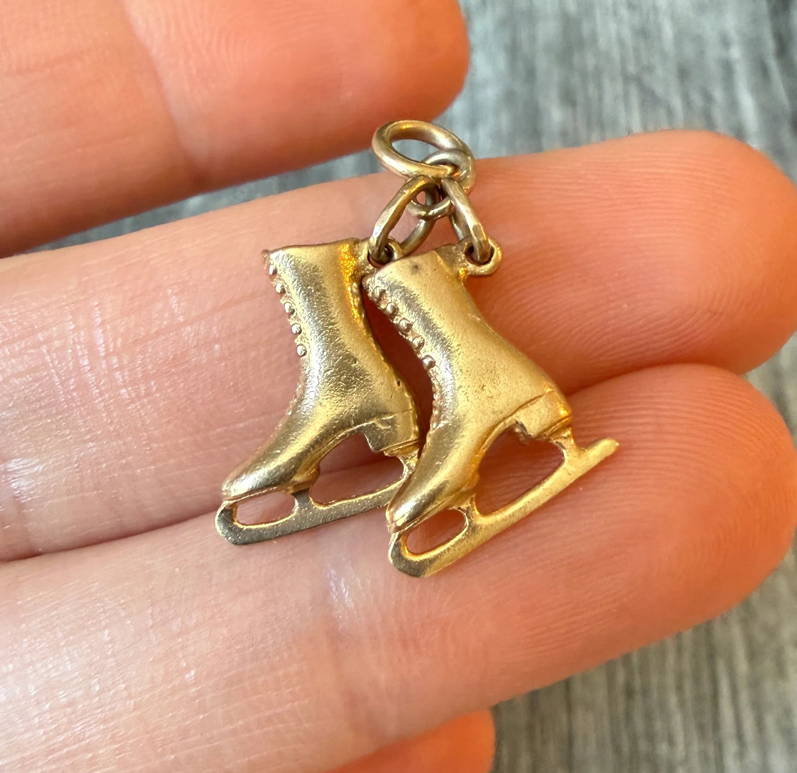 Vintage Pair of Ice Skates Charm in 14K Gold: Metal: 14K Yellow Gold Weight: 3.7 gramsMeasurements: 0.75 inches long Markings: "14K"Condition: In very good condition with some minor surface wear