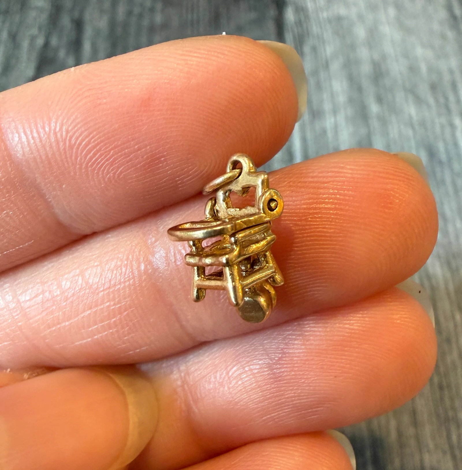 Vintage Articulated Highchair Charm in 14K Gold: Metal: 14K Yellow Gold Weight: 1.7 gramsMeasurements: 0.5 inches long by 0.3 inches wideMarkings: "14K"Condition: In very good vintage condition with some minor surface wear