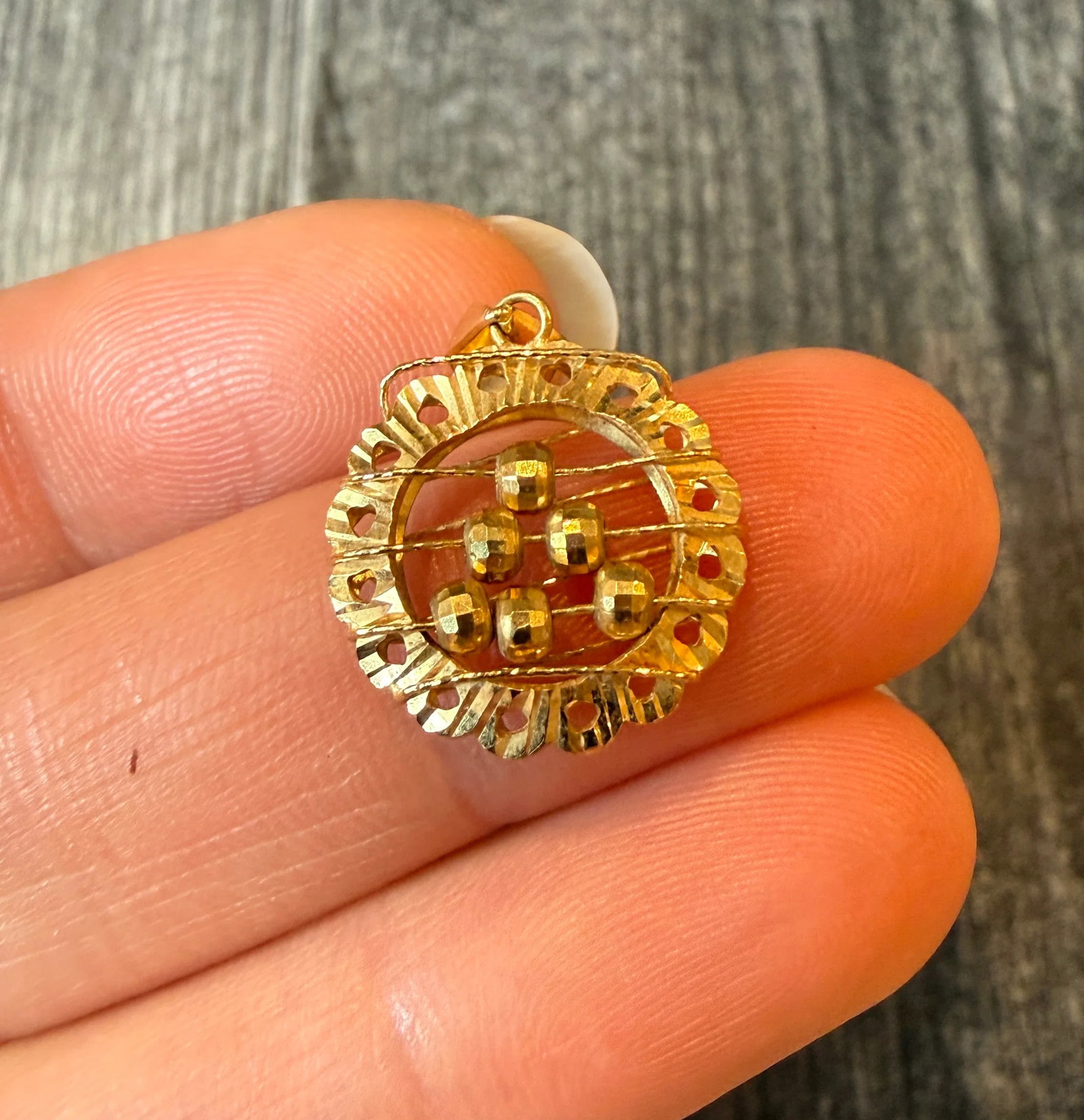 Round Abacus Charm in 18K Gold: Metal: 18K Yellow Gold Weight: 1.7 gramsMeasurements: 0.65 inches diameter Markings: "18K"Condition: In good condition with some minor surface wear