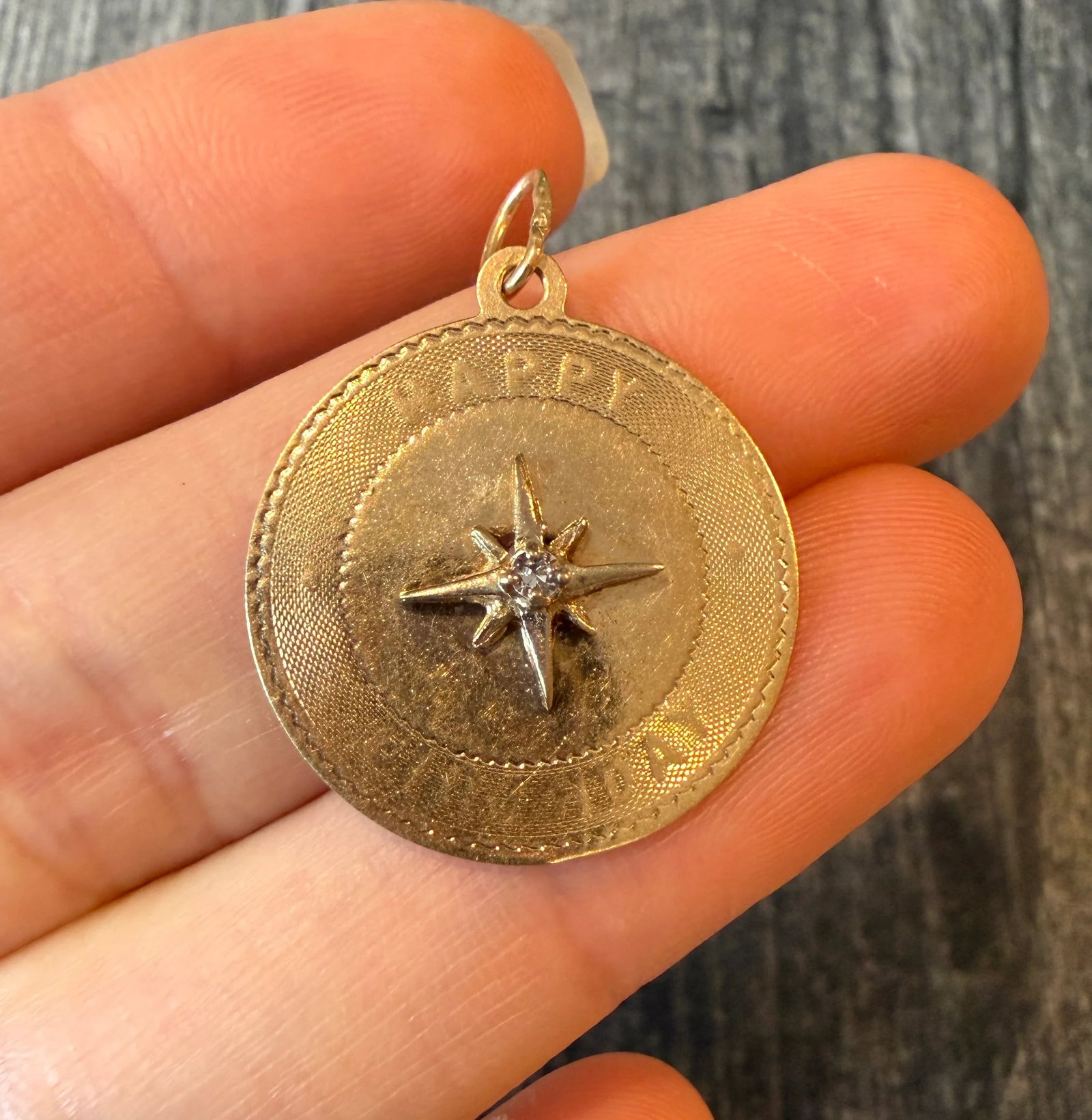 Happy Birthday North Star Diamond Charm in 14K Gold: Metal: 14K Yellow GoldWeight: 2.3 gramsMeasurements: 0.9 inch diameter Markings: faded "M & M 14K"Condition: In good condition with some minor surface wear