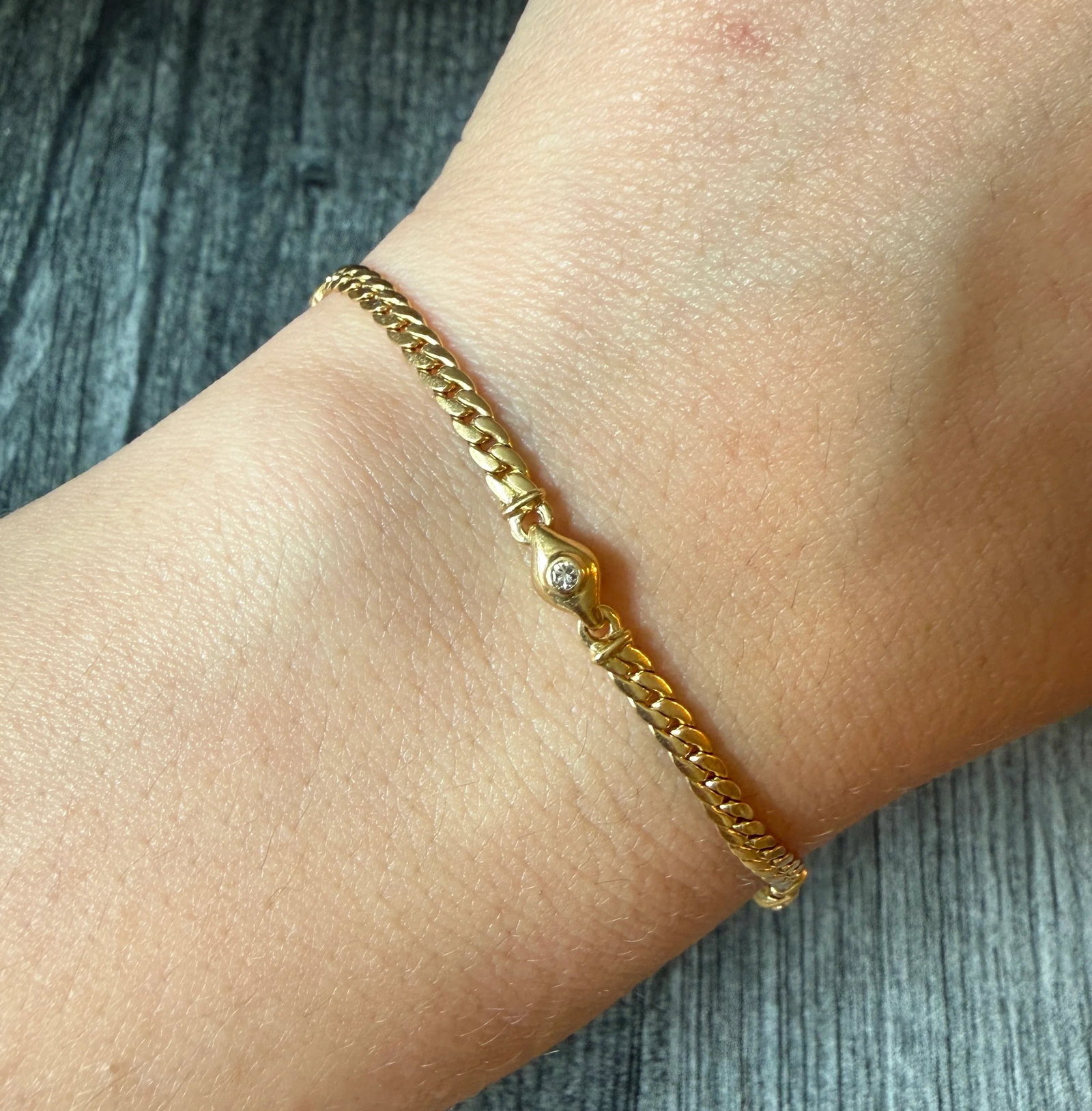 Diamond Station and 18K Gold Curb Link Bracelet, 7.5?? Long: Metal: 18K Yellow Gold (Acid Tested)Weight: 6.4 gramsDiamonds: Approximately 0.06 carats Measurements: 7.5 inches long by 4.1 mm wide Markings: Maker’s markCondition: In very good condition with