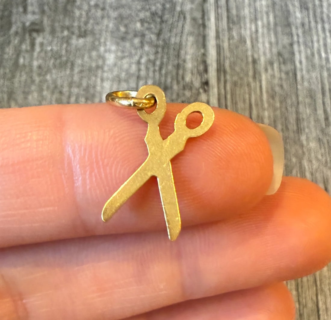 Small 18K Gold Scissor Charm: Metal: 18K Yellow Gold (acid tested)Weight: 0.9 gramsMeasurements: 0.6 inches long by 0.35 inches wideMarkings: “750”Condition: In very good condition with some minor surface wear.Follow us on