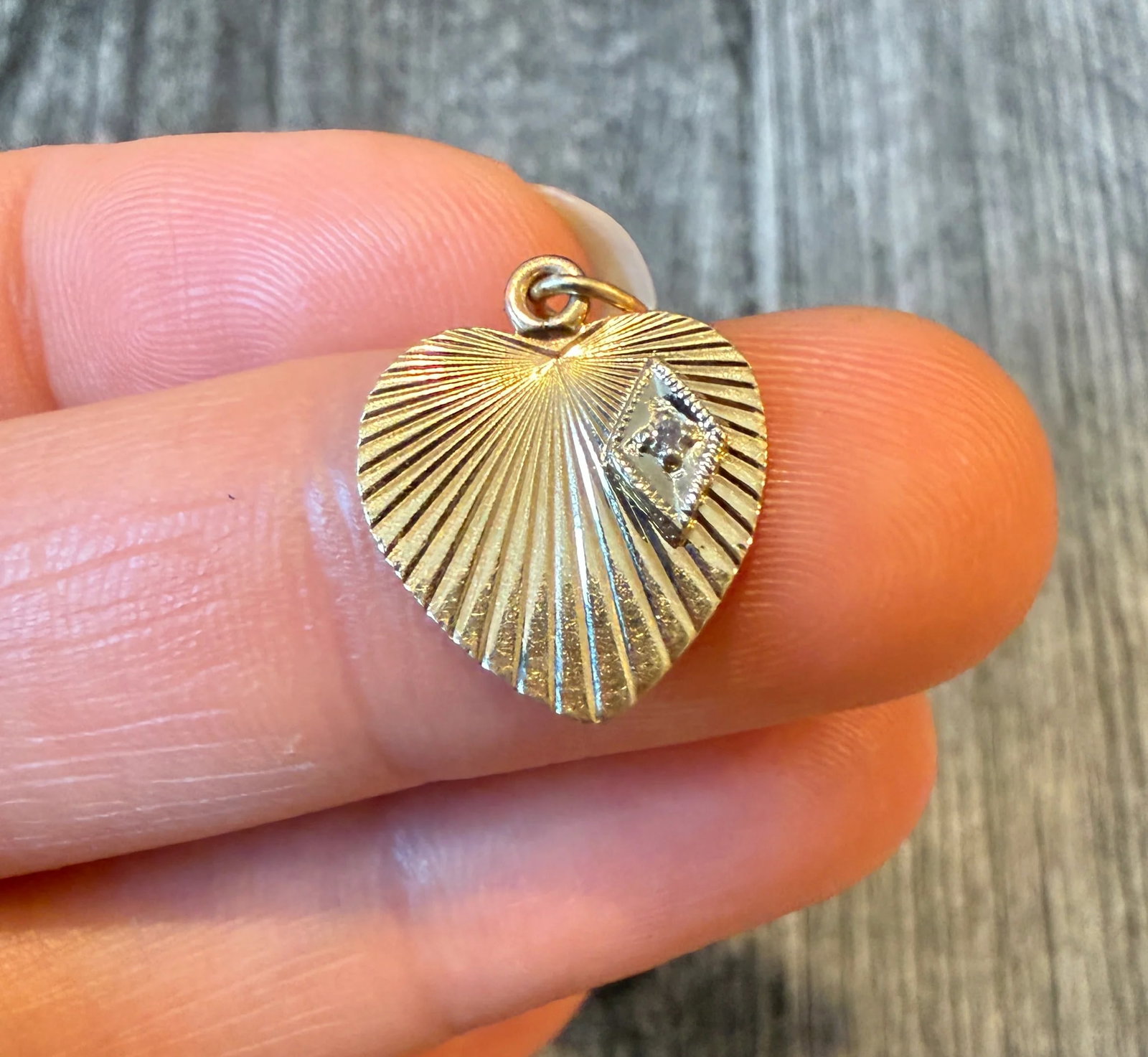 Mini Engine Turned Heart Charm with Diamond Accent 2/2: Metal: 14K Yellow Gold (acid tested)Weight: 1.2 gramsMeasurements: 0.55 inches long by 0.5 inches wide Diamond: Approximately 0.01 caratCondition: In good condition with some minor surface wear.Follow