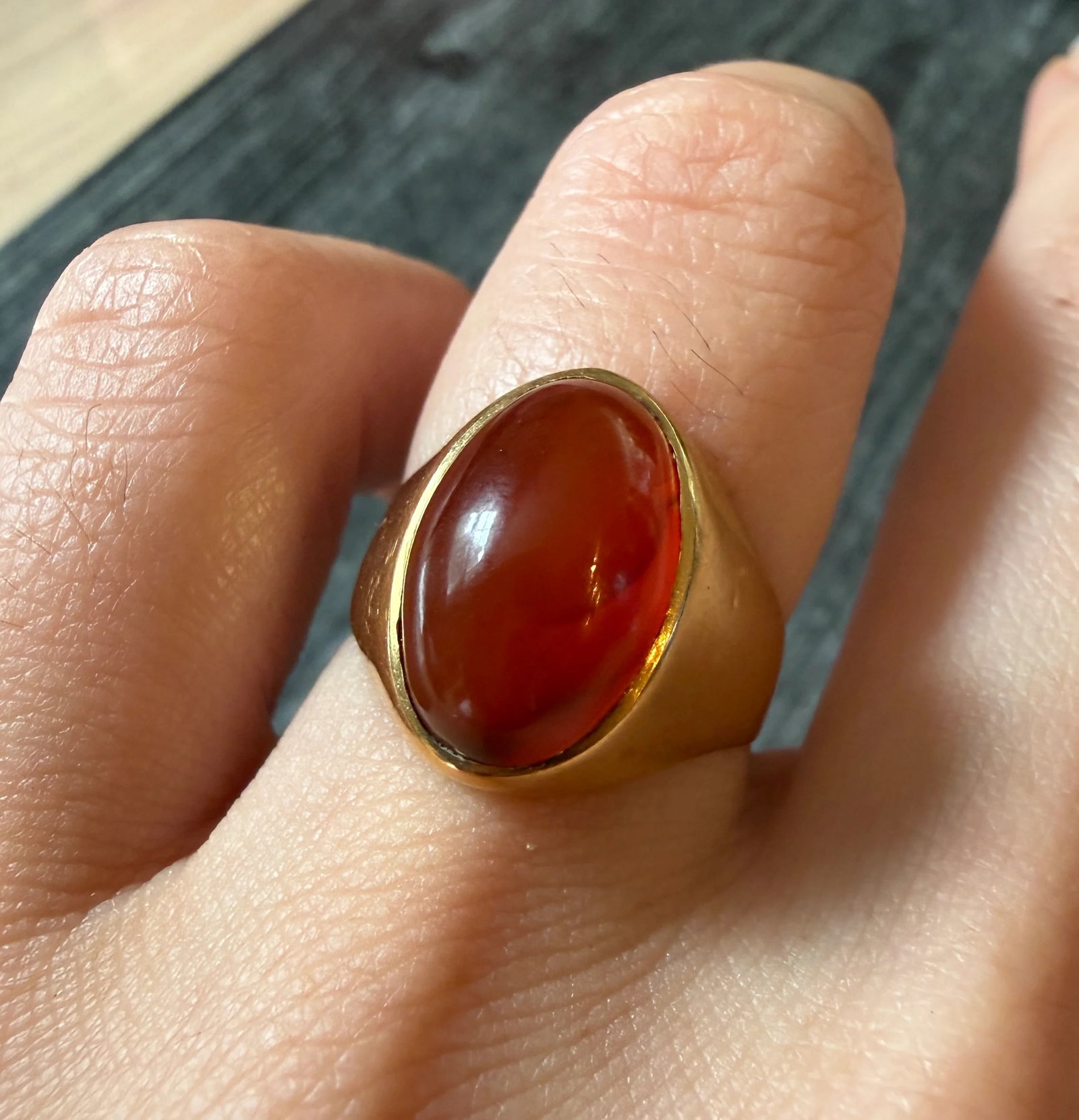 Glowing Carnelian Signet Ring in 18K Gold: Metal: 18K Yellow GoldWeight: 5.3 gramsRing Size: 6.75Condition: In very good condition with some minor surface wear.Follow us on Instagram @alphaomegajewelry for the latest updates from our shop! We
