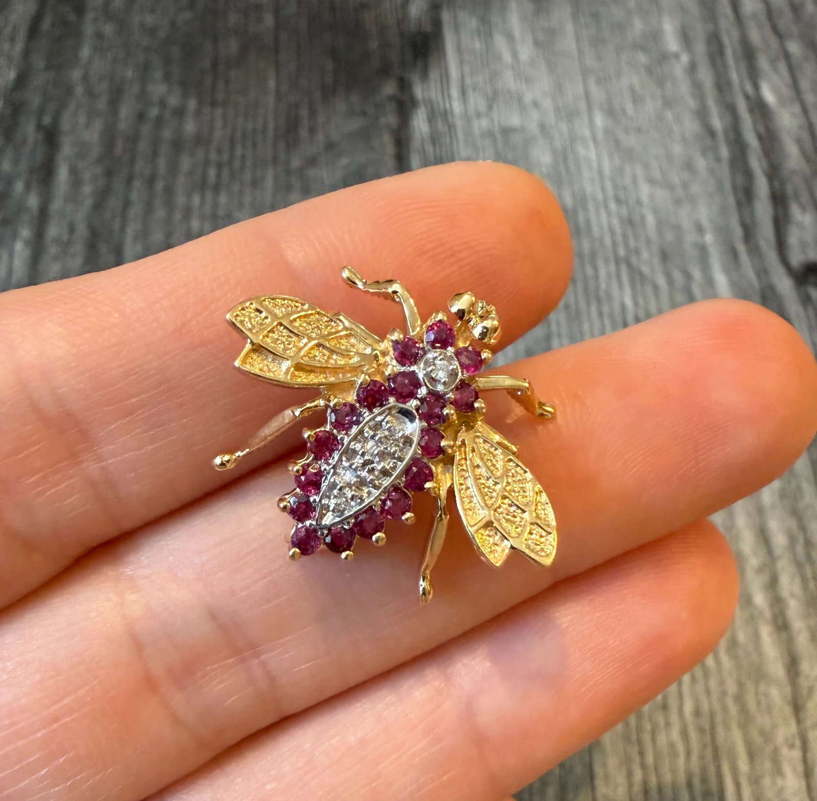 Diamond and Ruby Bee Pin in 14K Gold: Metal: 14K Yellow and White Gold Weight: 3.7 gramsDiamonds: Approximately 0.04 caratsRubies: Approximately 0.36 caratsMeasurements: 0.8 inches long by 1 inch wideMarkings: “GM 14K”Condition: I