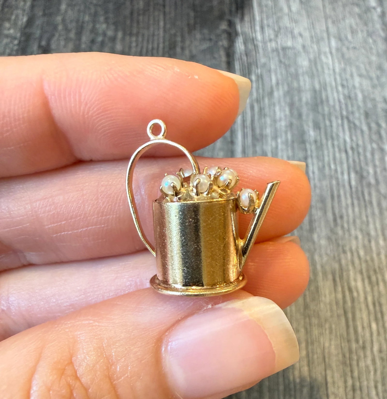 Gardener’s Watering Can Charm with Pearls in 14K Gold: Metal: 14K Yellow Gold Weight: 3.6 gramsMeasurements: 0.75 inches long by 0.85 inches wideMarkings: 14KCondition: In good condition with some minor surface wear. A bale can be added if requested prior