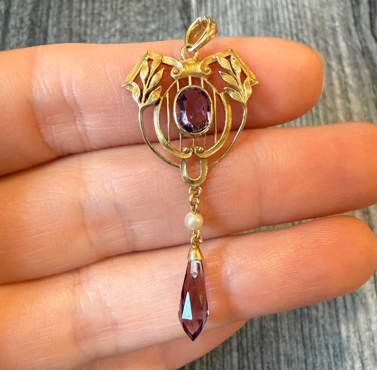 Art Nouveau Amethyst and Pearl Lavalier in 14K Gold: Metal: 14K Yellow Gold Weight: 2.8 gramsMeasurements: 1.75 inches long by 0.9 inches wide Markings: "14K"Condition: In very good condition with some minor surface wear.Follow us on Instagram @alphaome