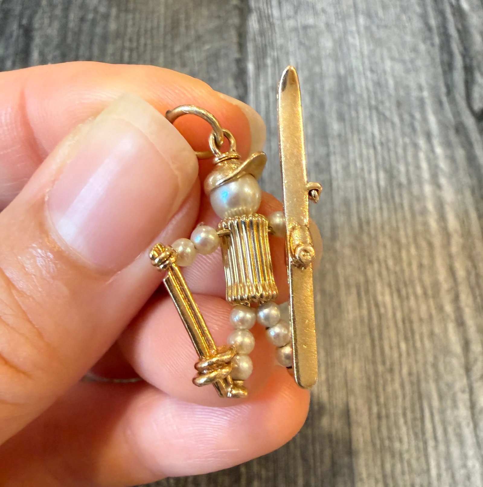 1960s Pearl Skier Charm in 14K Gold: Metal: 14K Yellow Gold Weight: 4 gramsMeasurements: 1.3 inches long by 0.75 inches wideMarkings: "14K"Condition: In very good condition with some minor surface wear.Follow us on Instagram @alphaomegaj
