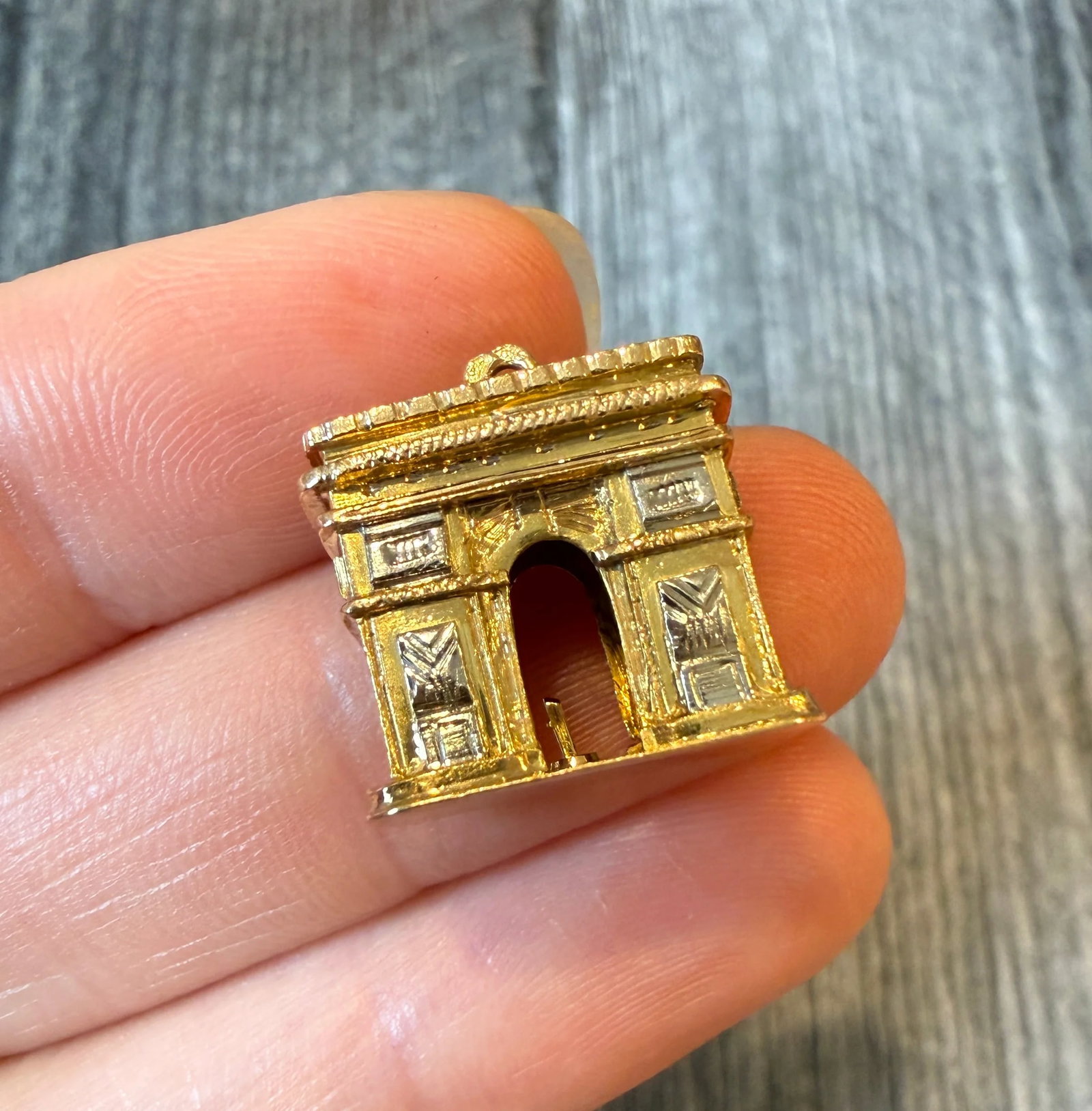 French Arc De Triomphe Charm in 18K Bicolor Gold: Metal: 18K Yellow and White GoldWeight: 5.5 grams Measurements: 0.55 inches long by 0.65 inches wideMarkings: French eagle headCondition: In very good condition with some minor surface wear.Follow us 