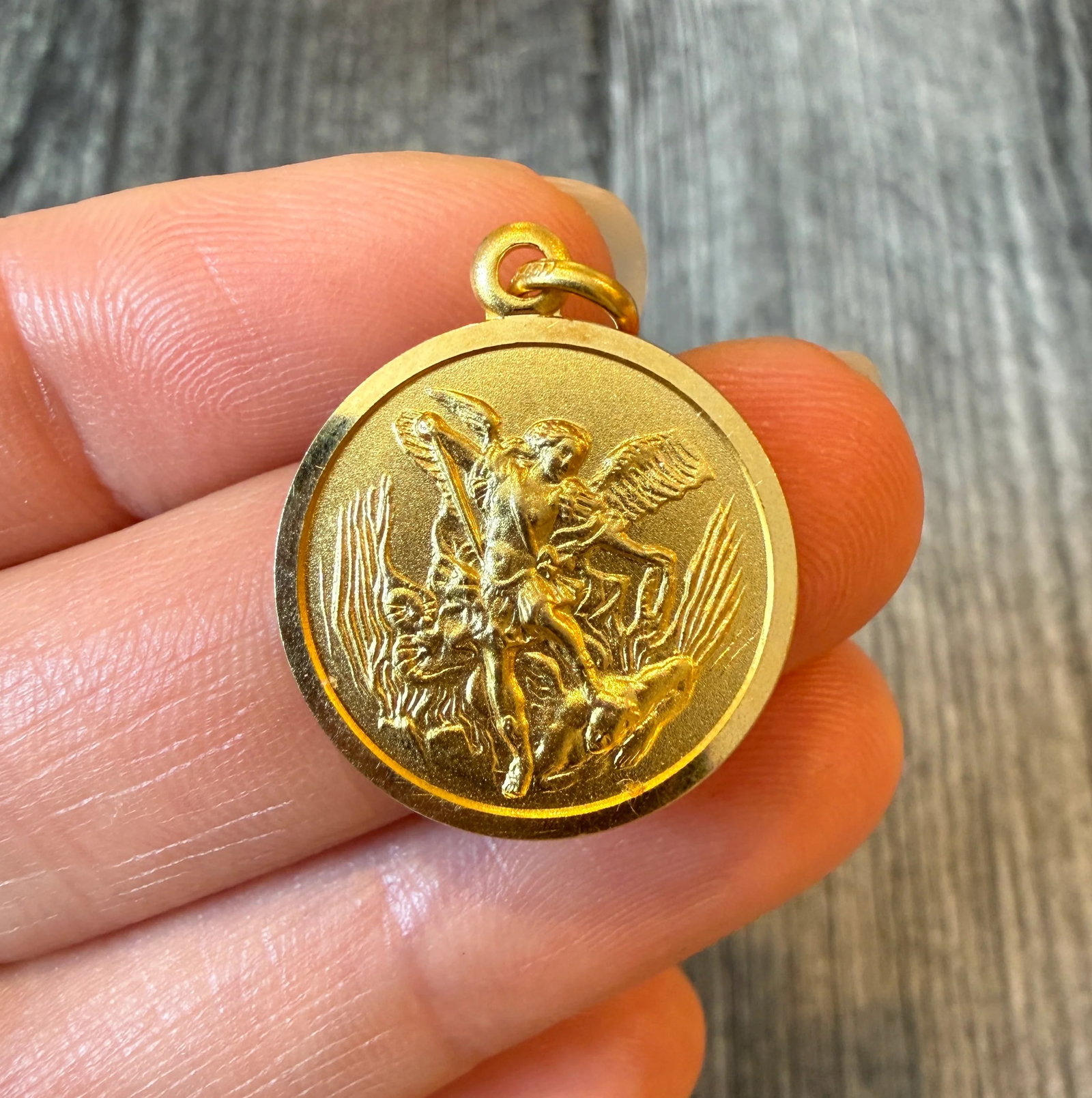 Solid Saint Michael Medal in 18K Gold: Metal: 18K Yellow GoldWeight: 4.8 gramsMeasurements: 0.8 inches diameter Markings: "750"Condition: In very good condition with some minor surface wear.Follow us on Instagram @alphaomegajewelry for the