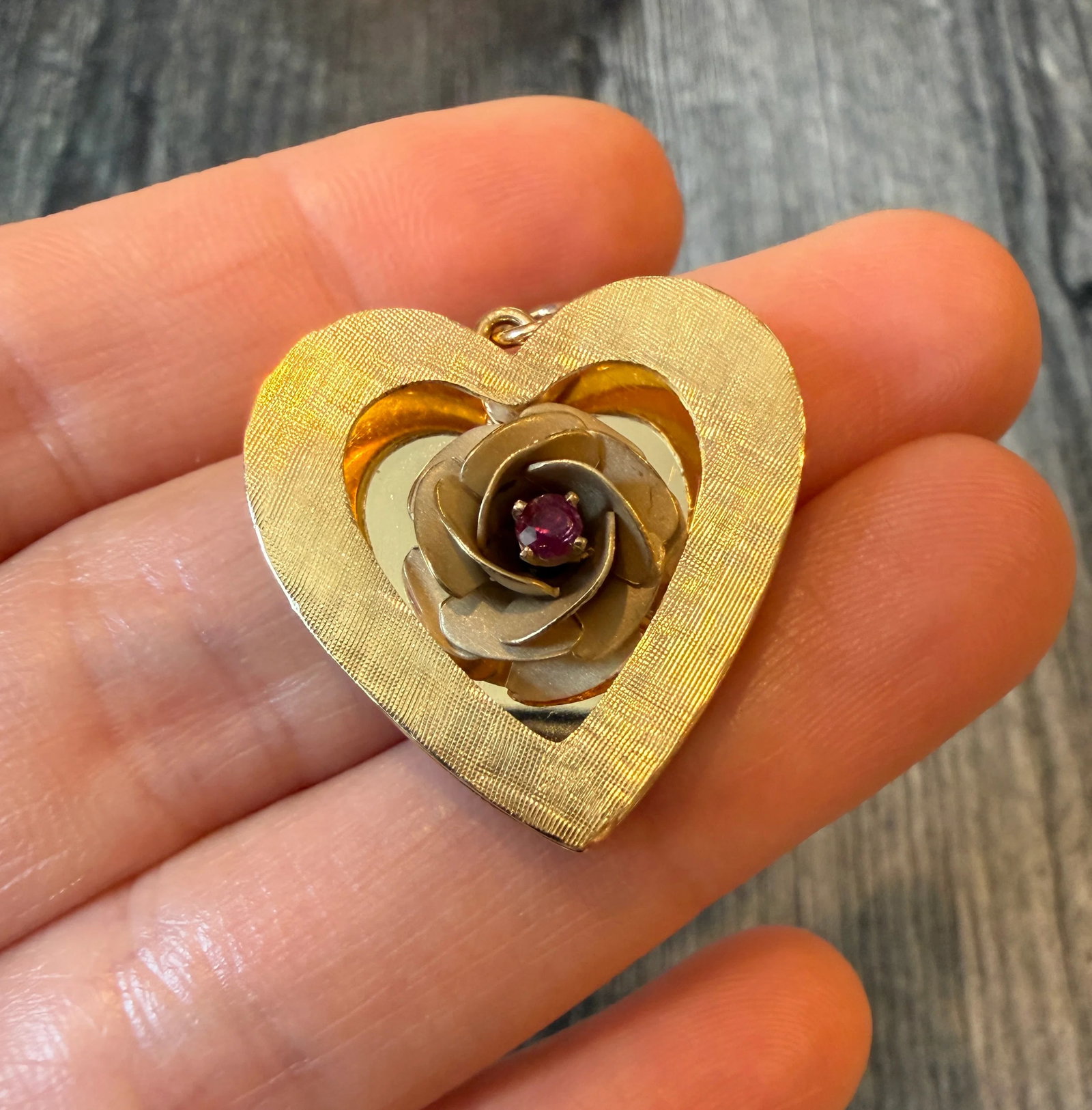 Vintage Heart and Rose Charm in 14K Gold: Metal: 14K Yellow Gold Weight: 7.2 gramsMeasurements: 1 inch long by 1 inch wideMarkings: "14K"Condition: In good condition with some minor surface wear consistent with age. A bale can be added if req