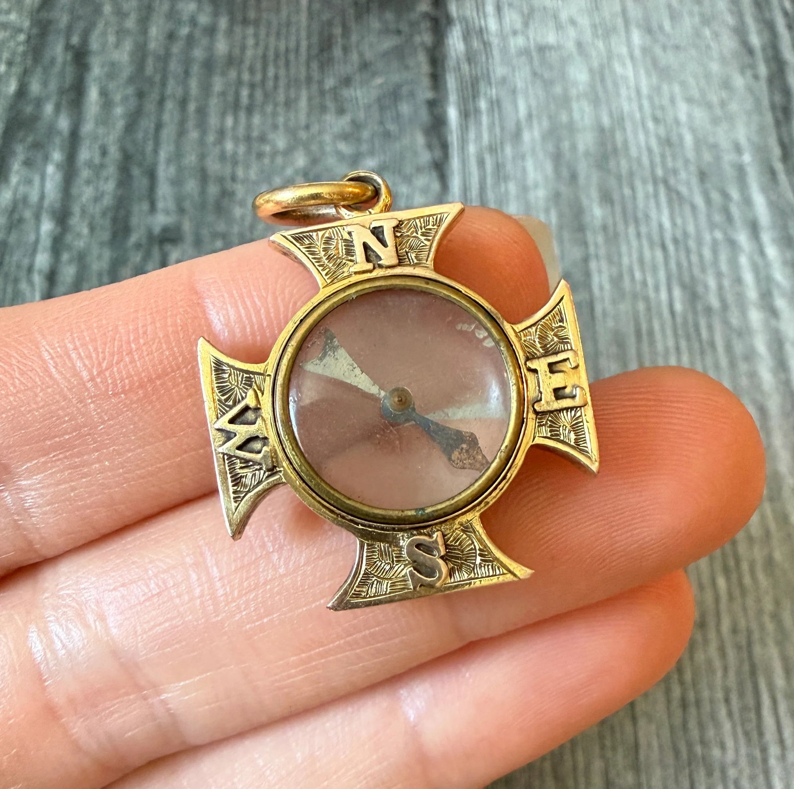 Antique Maltese Cross Compass Charm in 10K Gold: Metal: 10K Yellow Gold (acid tested)Weight: 5.4 gramsMeasurements: 1 inch long by 1 inch wide Condition: The compass does not consistently point north. It's in fair antique condition with some minor s