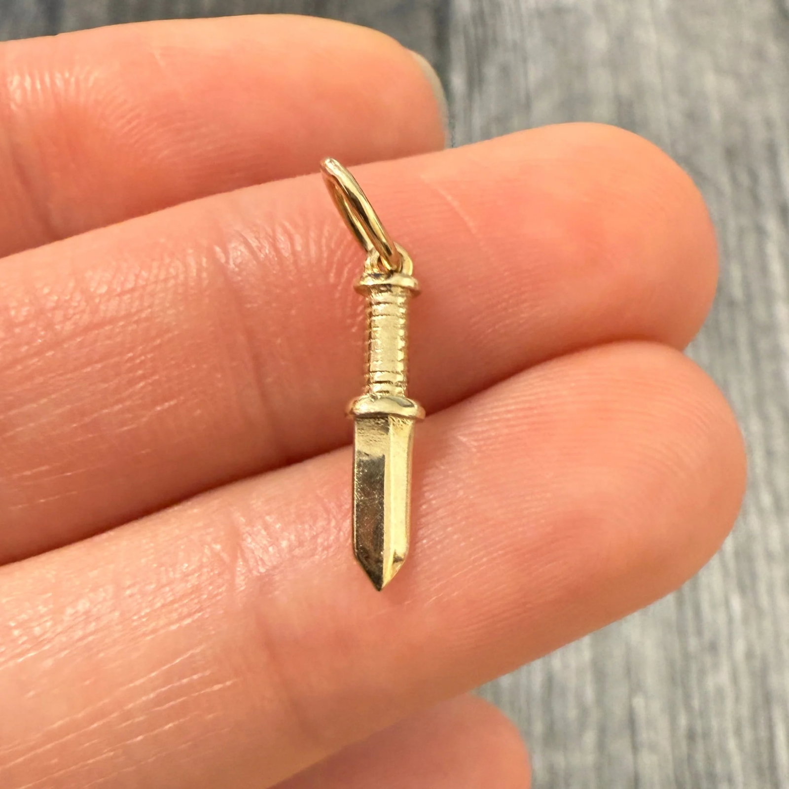 Mini 14K Gold Dagger Charm: Metal: 14K Yellow Gold Weight: 0.7 gramsMeasurements: 0.6 inches long by 0.15 inches wideMarkings: "14Kt ITALY"Condition: In very good condition with some minor surface wear consistent with age. Follo