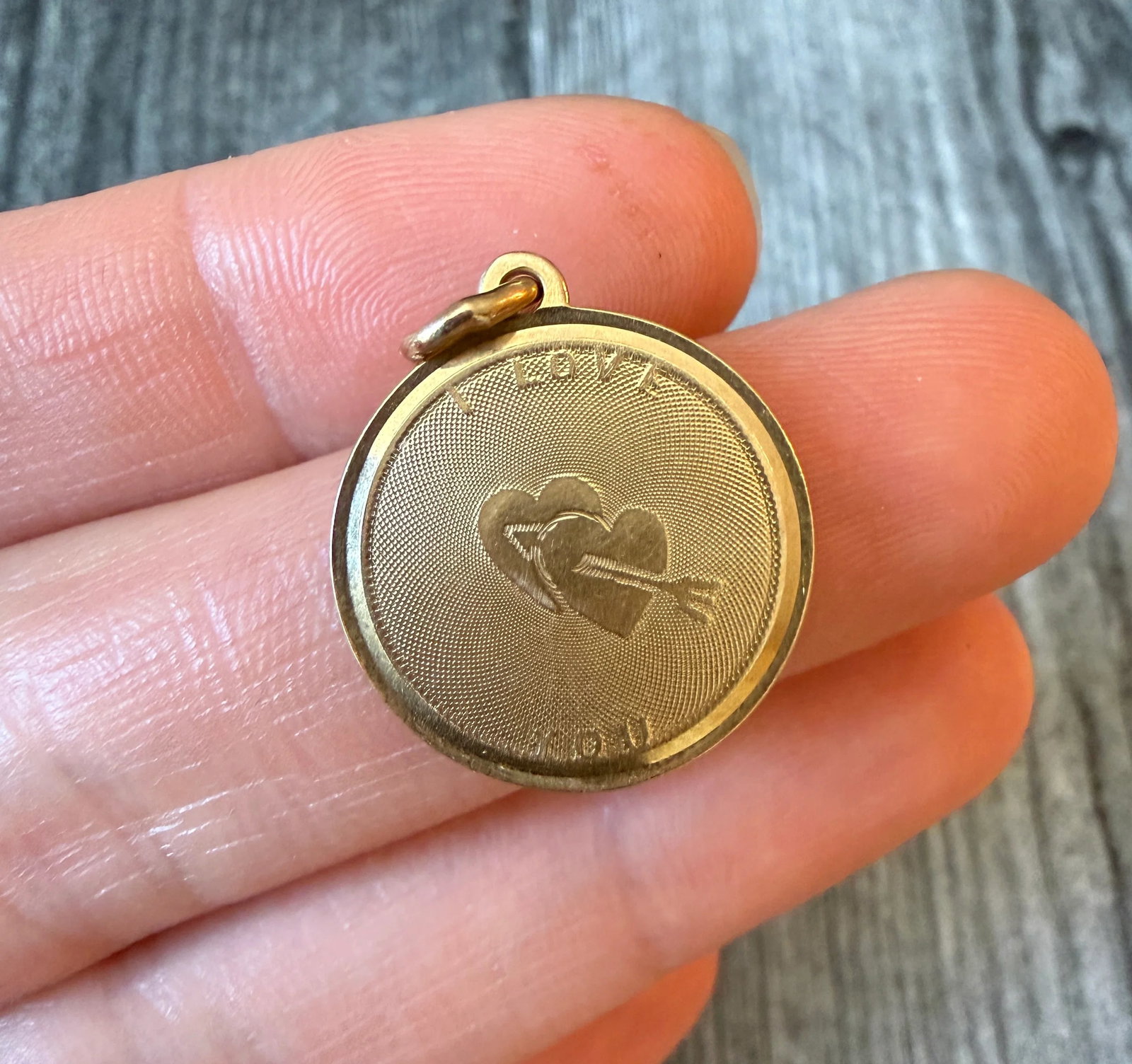 "I LOVE YOU" Shot Through the Heart Charm in 14K Gold by Larter & Sons: Metal: 14K Yellow Gold Weight: 3.7 gramsMeasurements: 0.75 inch diameter Markings: "14" with maker’s markCondition: In very good condition with some minor surface wear Follow us on Instagram @alphao