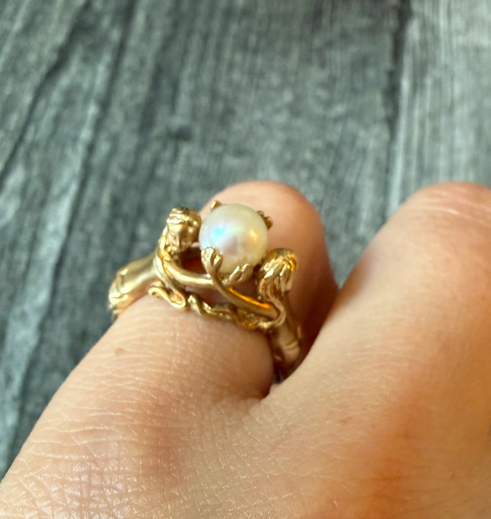 Figural Ring of Mermaids or Women Holding a Pearl in 14K Gold: Metal: 14K Yellow GoldWeight: 8.3 gramsRing Size: 6 (resizable but it will interrupt the design of the shank)Pearl: 6.8 mm diameter Markings: "14K"Condition: In good vintage condition with some minor 