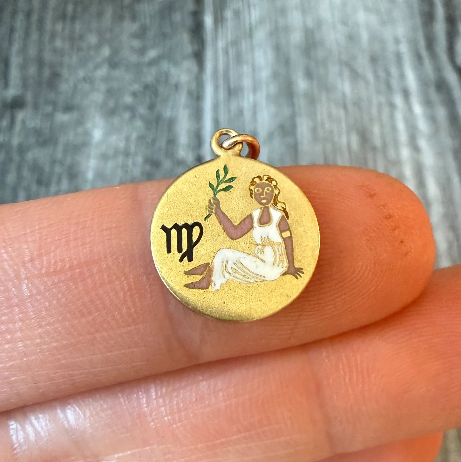 Art Deco Enamel Virgo Zodiac Charm in 14K Gold: Metal: 14K Yellow Gold Weight: 1.6 gramsMeasurements: 0.5 inch diameter Markings: "14K"Condition: In good condition with some minor surface wear consistent with ageFollow us on Instagram @alphaomegaje