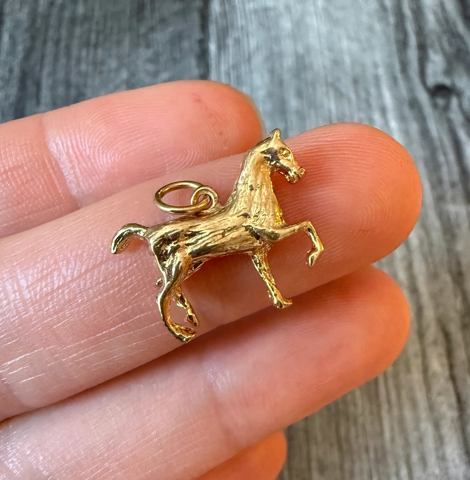 Horse Charm in 14K Gold: Metal: 14K Yellow Gold (acid tested)Weight: 2.7 gramsMeasurements: 0.7 inches long by 0.75 inches wideCondition: In very good condition with some minor surface wear Follow us on Instagram @alphaomegaj