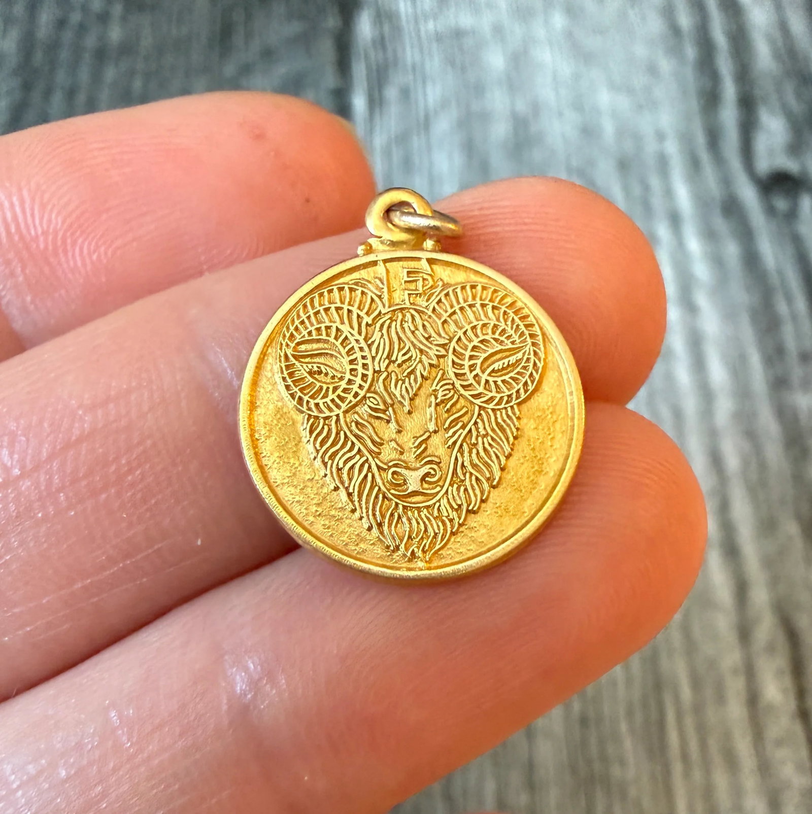 Ram’s Head Aries Zodiac Charm in 14K Gold: Metal: 14K Yellow Gold Weight: 1.7 gramsMeasurements: 0.7 inch diameterMarkings: "14K"Condition: In good condition with some minor surface wear Follow us on Instagram @alphaomegajewelry for the