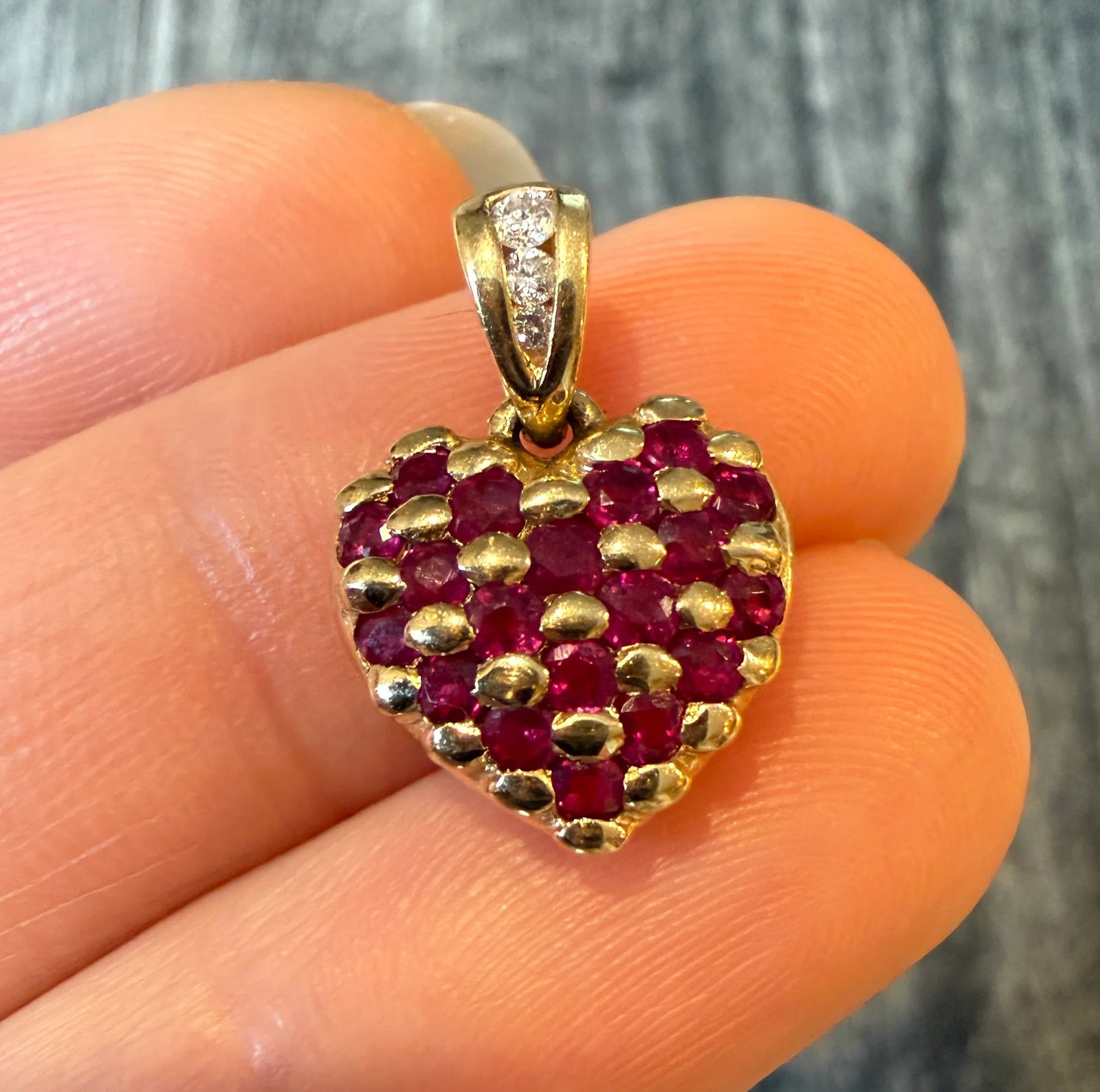 Small Natural Ruby and Diamond Heart Charm: Metal: 14K Yellow Gold Weight: 2.6 gramsRubies: Approximately 0.60 caratsDiamonds: Approximately 0.08 caratsMeasurements: 0.5 inches long by 0.5 inches wideMarkings: "14K"Condition: In very good condi