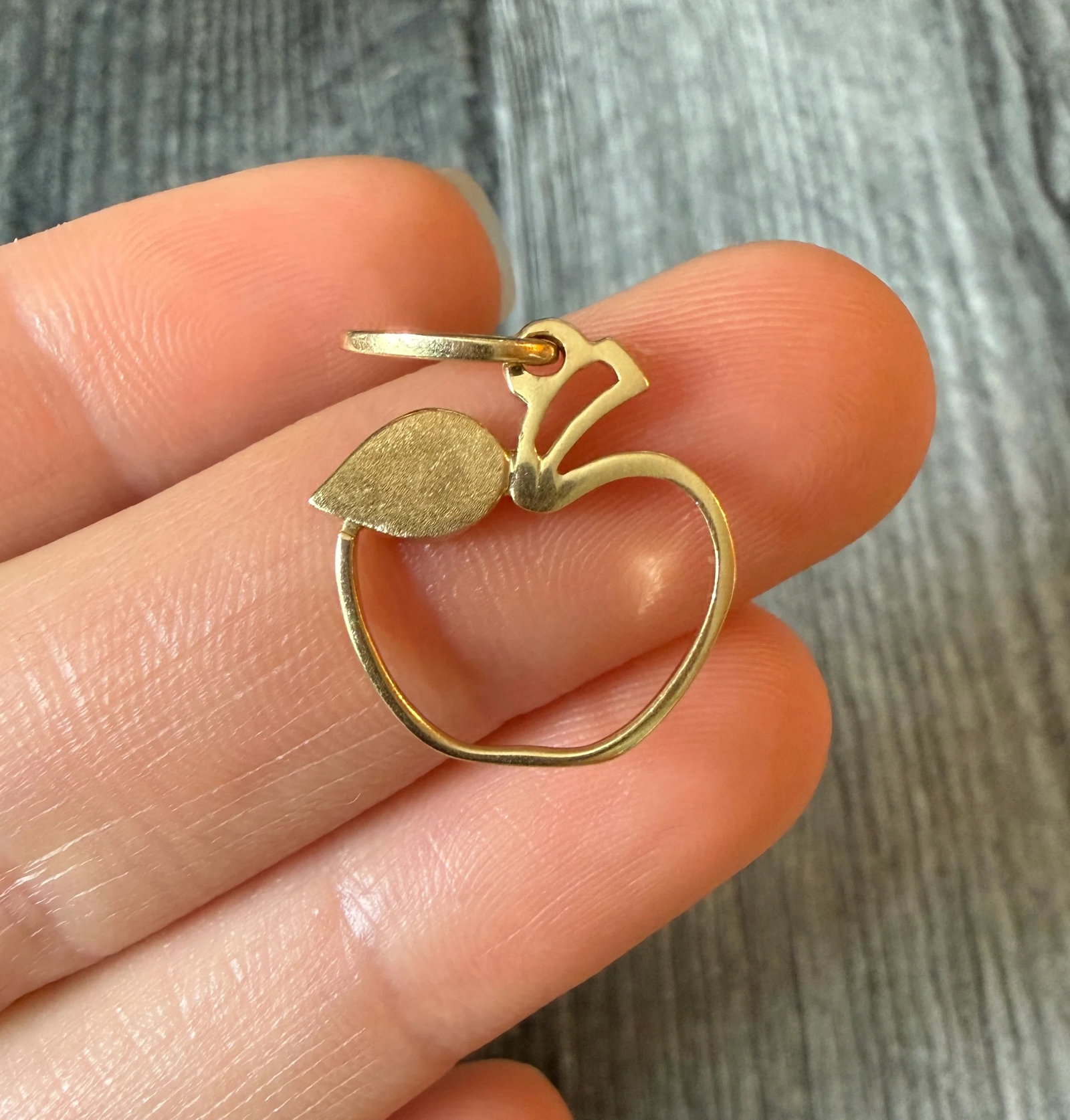 Apple Charm in 14K Gold: Metal: 14K Yellow Gold Weight: 1.7 gramsMeasurements: 0.75 inches long by 0.7 inches longMarkings: "14Kt ITALY"Condition: In very good condition with some minor surface wear Follow us on Instagram