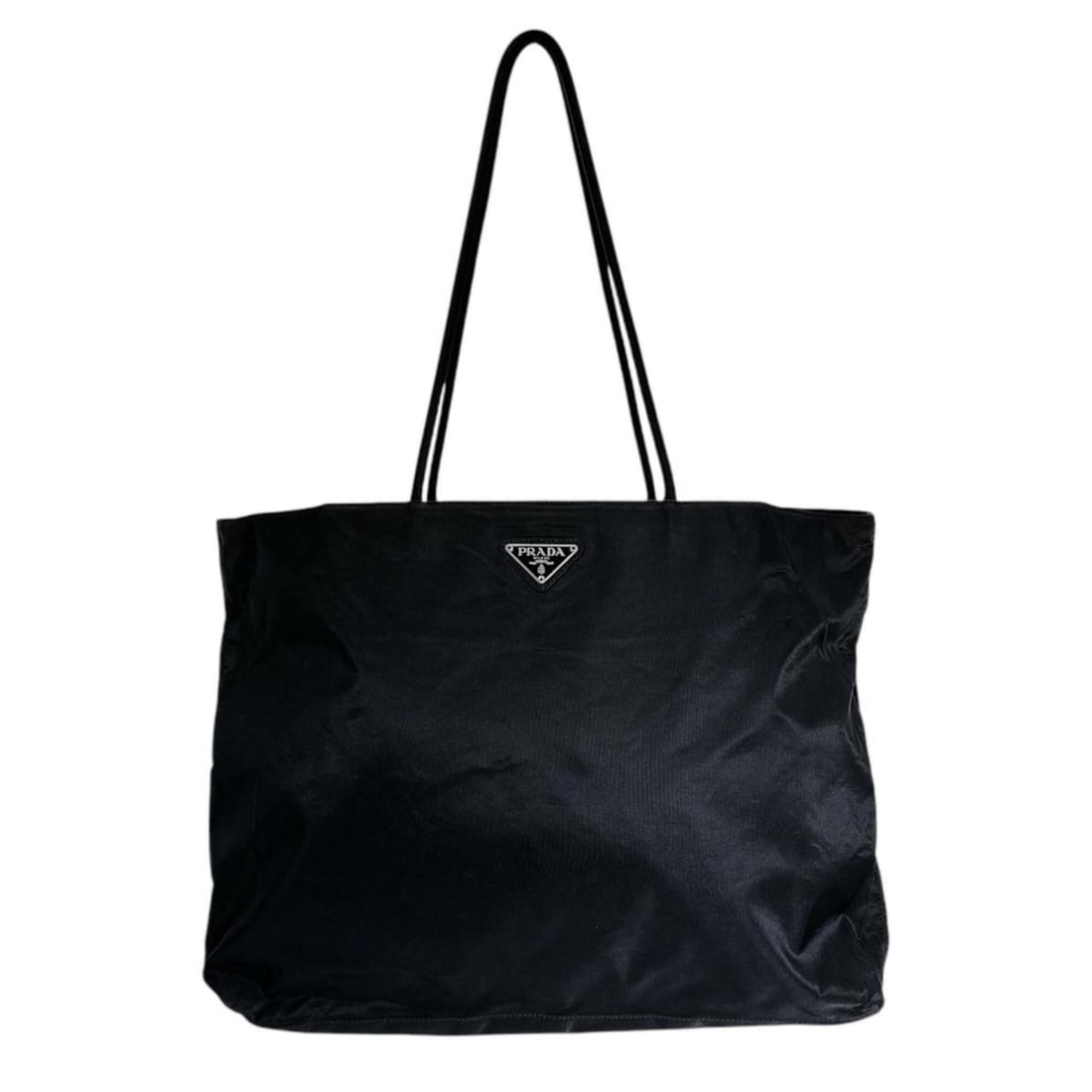Prada tote bag with triangle logo, nylon, black.: --- Catalog ---Category: SizeSize (HxWxD): 29cm x 43cm x 9cm / 11.41'' x 16.92'' x 3.54''Category: DesignType: Tote bagColor: BlackGender: Men,WomenMaterial: Nylon Category: GeneralBrand: PradaCountry