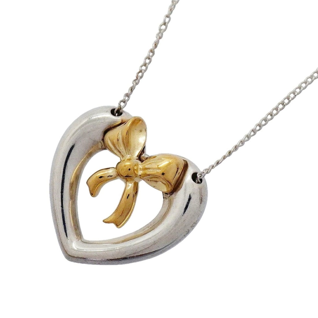 Tiffany & Co. Necklace, Heart Ribbon Design, 18K Yellow Gold (KYG), Sterling Silver (925), Women's: --- Catalog ---Category: SizePendant Size: 17.5mm x 18.3mm / 0.68'' x 0.72''Neck Circumference: 48.5 cm / 19.09''Category: DesignGender: WomenMaterial: Silver 925, Yellow gold (18K)Necklace Type: Neck