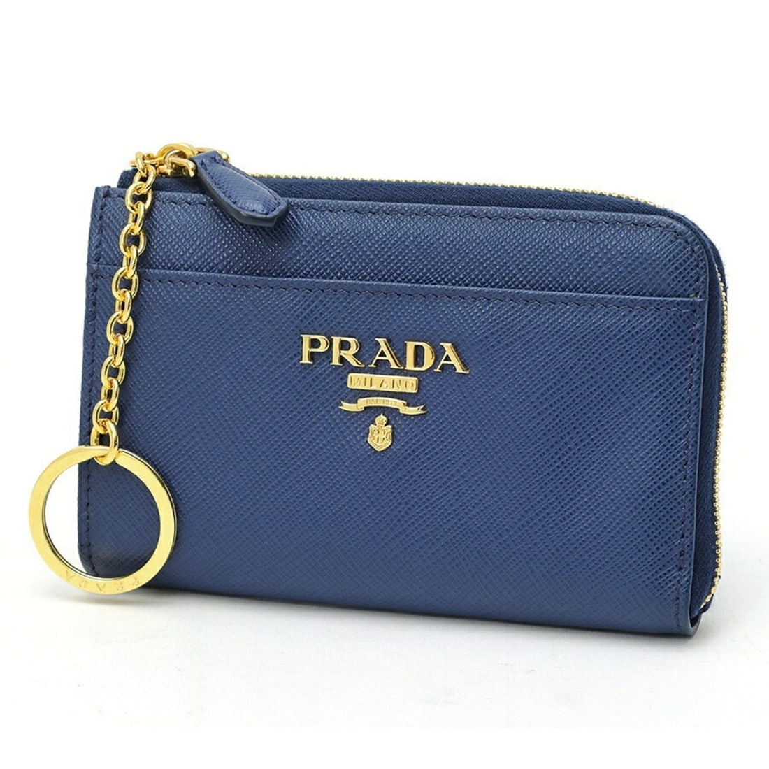 Prada Saffiano Leather Key Case Coin Purse 1PP122 Bluette (Blue): --- Catalog ---Category: DesignType: KeycaseColor: BluetteMaterial: Saffiano triangle , Leather Category: GeneralBrand: PradaCountry of Origin: ItalyCategory: Physical PropertiesSize (HxWxD): 8.5cm x 