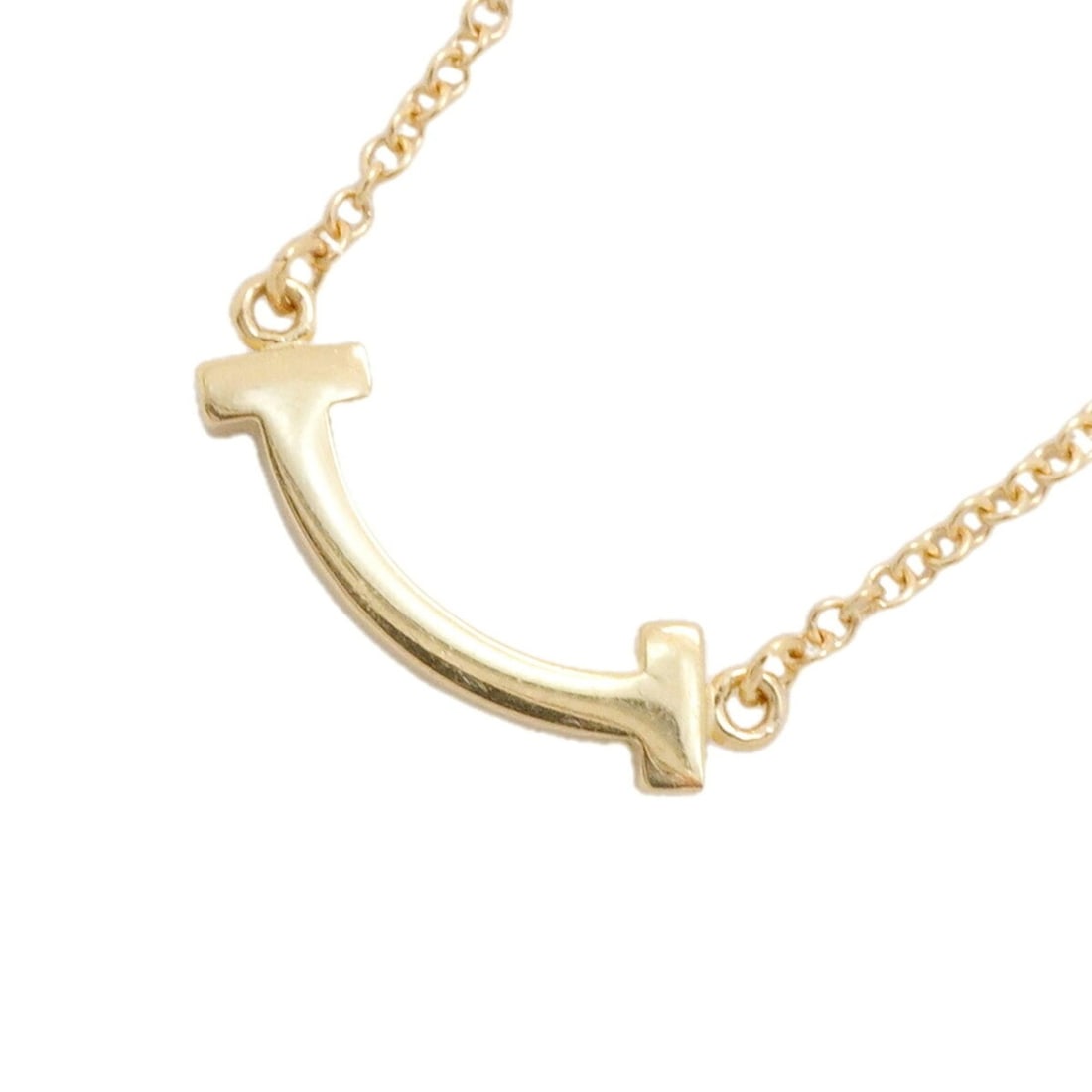 Tiffany & Co. T Smile Mini Necklace, 18K Yellow Gold, Women's: --- Catalog ---Category: SizePendant Size: 4.6mm x 14.2mm / 0.18'' x 0.55''Neck Circumference: 41 cm - 46 cm / 16.14'' - 18.11''Category: DesignGender: WomenMaterial: Yellow gold (18K)Necklace Type: N