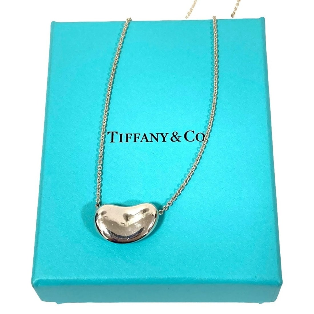 Tiffany & Co. Elsa Peretti Bean Chain Necklace, 925 Sterling Silver, Women's: --- Catalog ---Category: SizePendant Size: 18mm x 20mm / 0.7'' x 0.78''Neck Circumference: 40.5 cm / 15.94''Category: DesignColor: SilverGender: WomenMaterial: Sterling silver 925Necklace Type: Neckla
