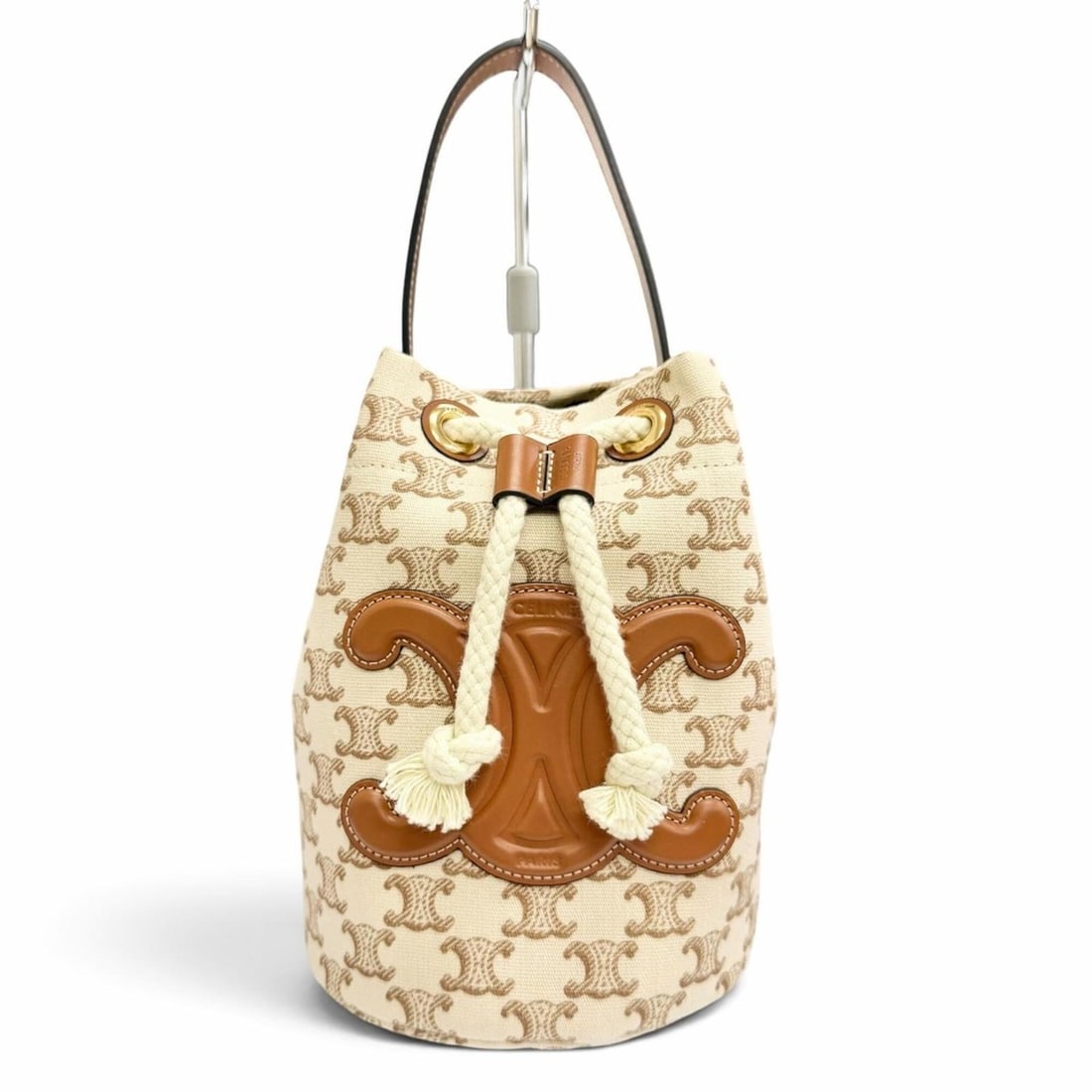 CELINE 19653 Teen Canvas Leather Triomphe Drawstring Handbag, Brown Beige, Gold Hardware, Made in: --- Catalog ---Category: SizeSize (HxWxD): 21cm x 15cm x 14cm / 8.26'' x 5.9'' x 5.51''Category: DesignType: HandbagColor: Beige, BrownGender: WomenMaterial: Canvas , Leather Hardware Color: GoldCateg