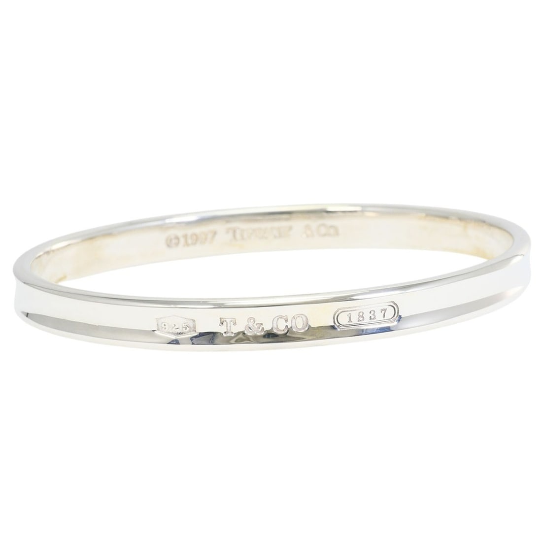 Tiffany & Co. 1837 Narrow Bangle, Silver, Total Weight 33.4g, Like New Condition.: --- Catalog ---Category: SizeLength: 20cm / 7.87''Weight: 33.4g / 1.17oz.Category: DesignType: BangleGender: WomenMaterial: Silver 925Category: GeneralLine: 1837 SeriesBrand: Tiffany--- Item List ---S