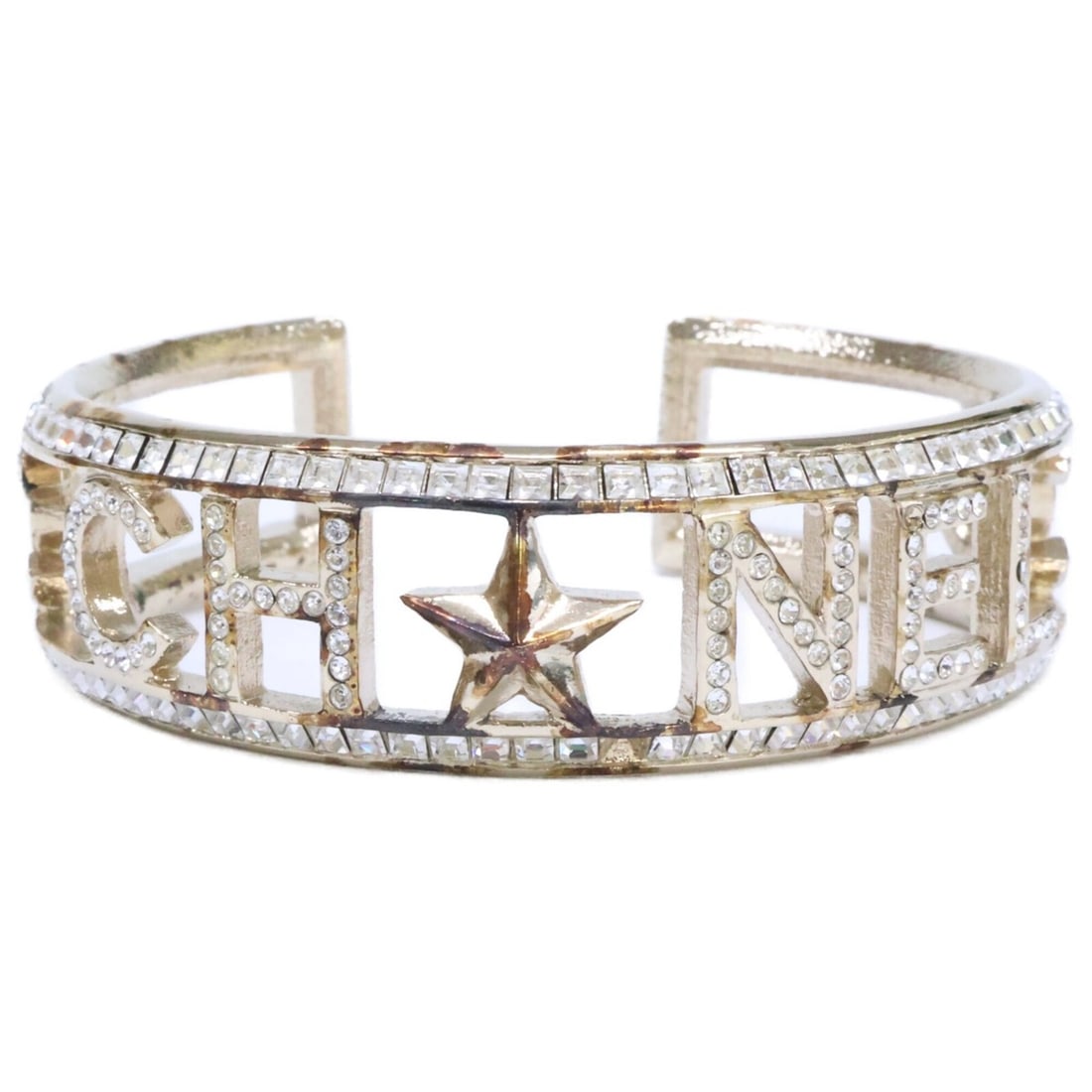 CHANEL A17C Rhinestone Logo Star Stud Coco Mark Bangle Light Gold Hardware Women's: --- Catalog ---Category: SizeLength: 16cm / 6.29''Category: DesignType: BangleGender: WomenMaterial: Gold platingCategory: GeneralBrand: Chanel--- Item List ---Section: ConditionRanking: Rank AB Used 