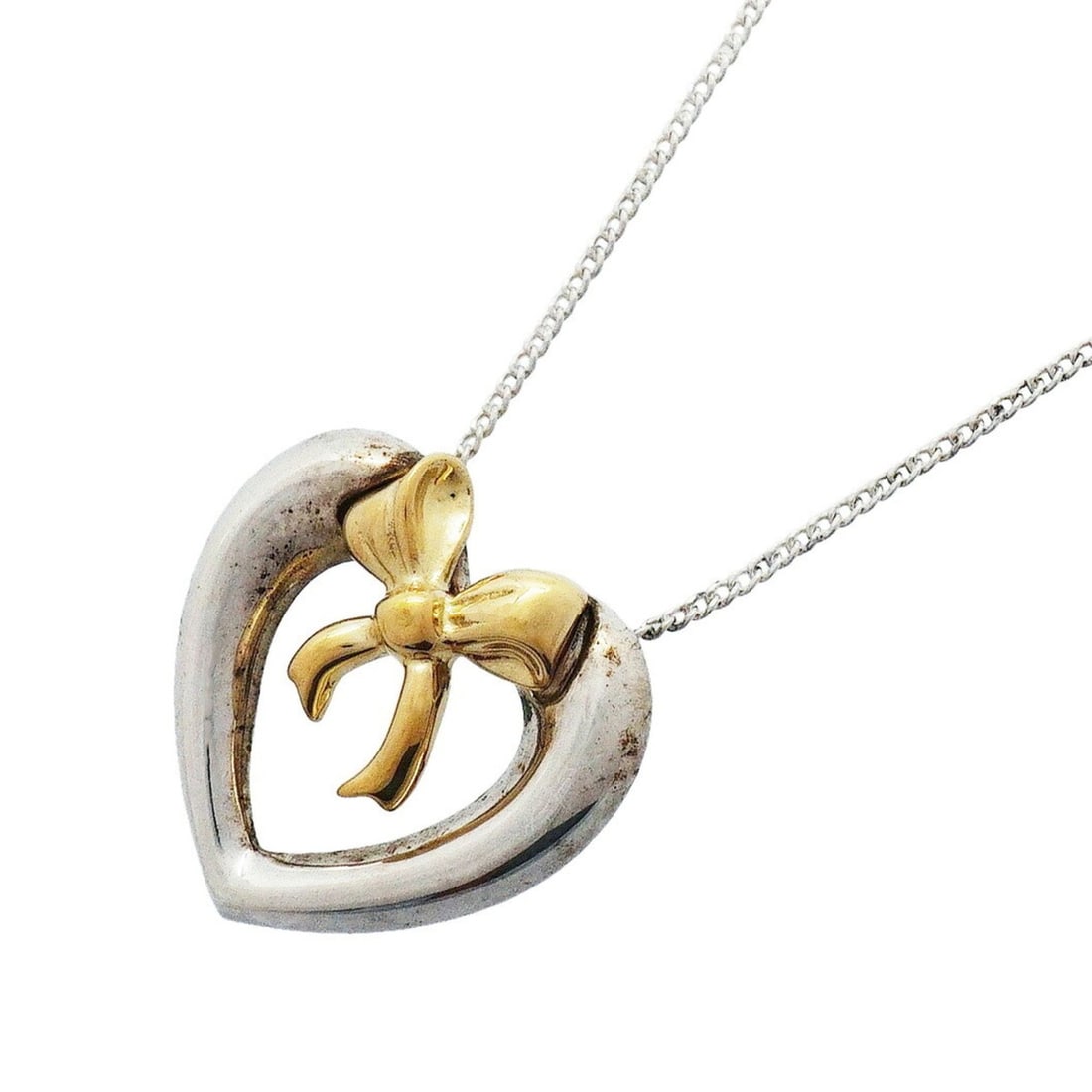 Tiffany & Co. Necklace, Heart Ribbon Design, 18K Yellow Gold (KYG), Sterling Silver (925), Women's: --- Catalog ---Category: SizePendant Size: 17.6mm x 18mm / 0.69'' x 0.7''Neck Circumference: 46 cm / 18.11''Category: DesignGender: WomenMaterial: Silver 925, Yellow gold (18K)Necklace Type: NecklaceC