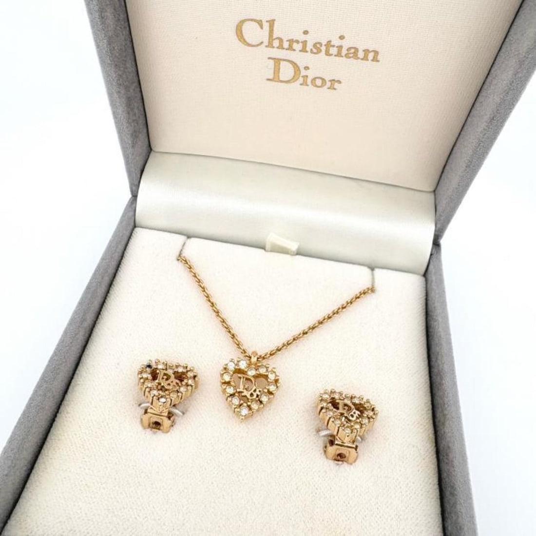 Christian Dior Gold Heart CD Logo Necklace and Earrings Set (2 pieces) with Case: --- Catalog ---Category: SizePendant Size: 18mm x 12mm / 0.7'' x 0.47''Neck Circumference: 38.5 cm - 43 cm / 15.15'' - 16.92''Category: DesignColor: GoldGender: WomenMaterial: Gold plating, Rhinestone