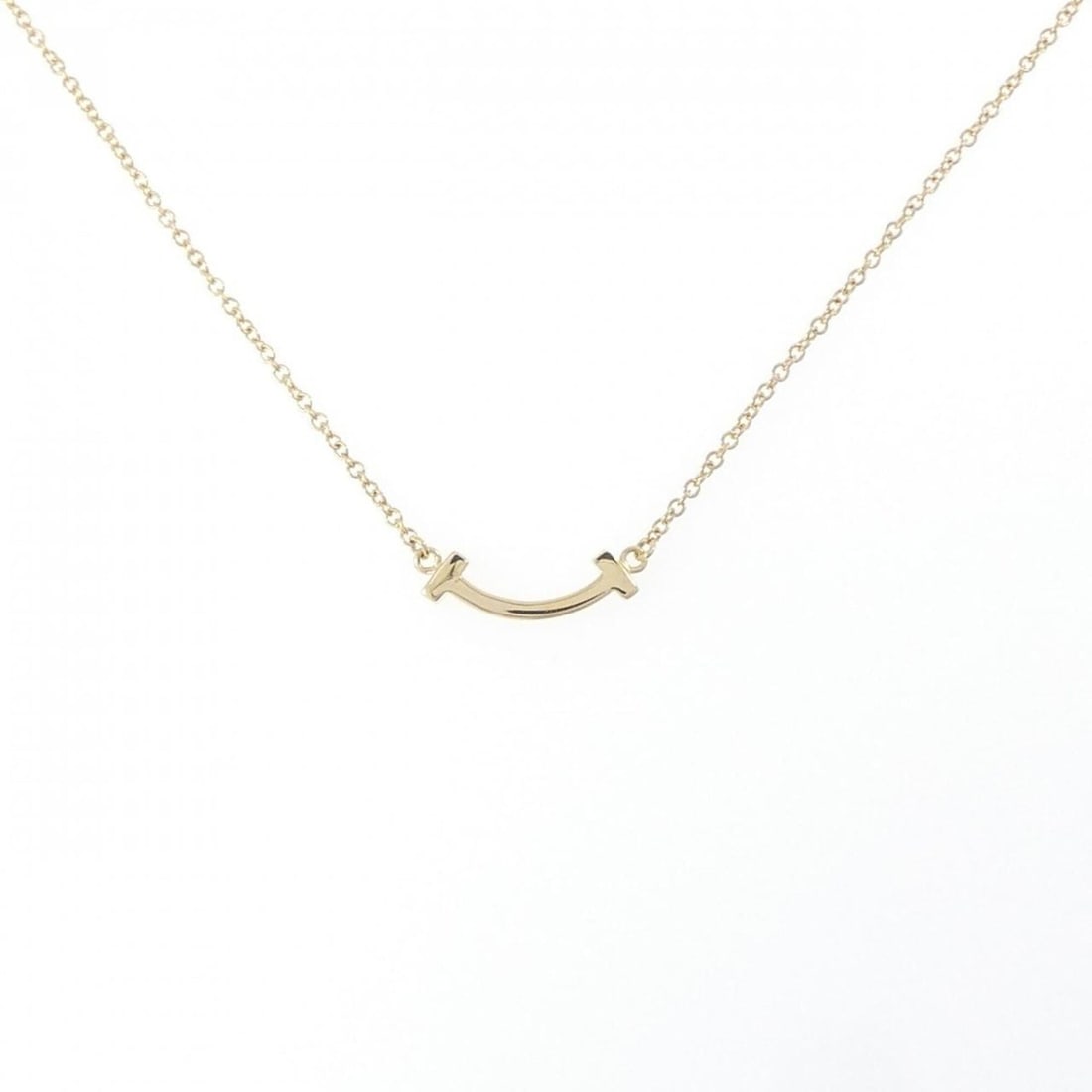 Tiffany T Smile Mini Necklace: --- Catalog ---Category: SizePendant Size: 4.4mm x 13.3mm / 0.17'' x 0.52''Neck Circumference: 41 cm - 46 cm / 16.14'' - 18.11''Category: DesignGender: WomenMaterial: Yellow gold (18K)Pendant Type: