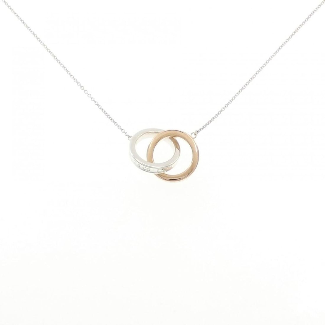 Tiffany & Co. 1837 Interlocking Necklace: --- Catalog ---Category: SizePendant Size: 14.4mm x 20.5mm / 0.56'' x 0.8''Neck Circumference: 41 cm / 16.14''Category: DesignGender: WomenMaterial: Pink gold (18K), Silver 925Pendant Type: