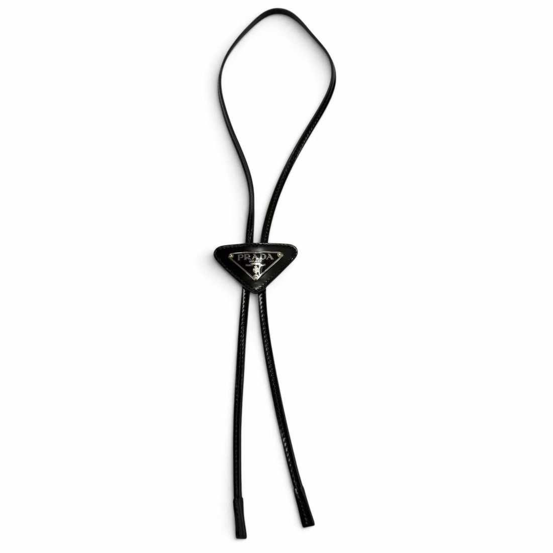 PRADA patent leather triangle plate bolo tie loop necklace, black with silver hardware, for men.: --- Catalog ---Category: SizePendant Size: 40mm x 65mm / 1.57'' x 2.55''Neck Circumference: 46 cm / 18.11''Category: DesignColor: BlackGender: MenMaterial: Patent leatherNecklace Type: NecklaceCategor