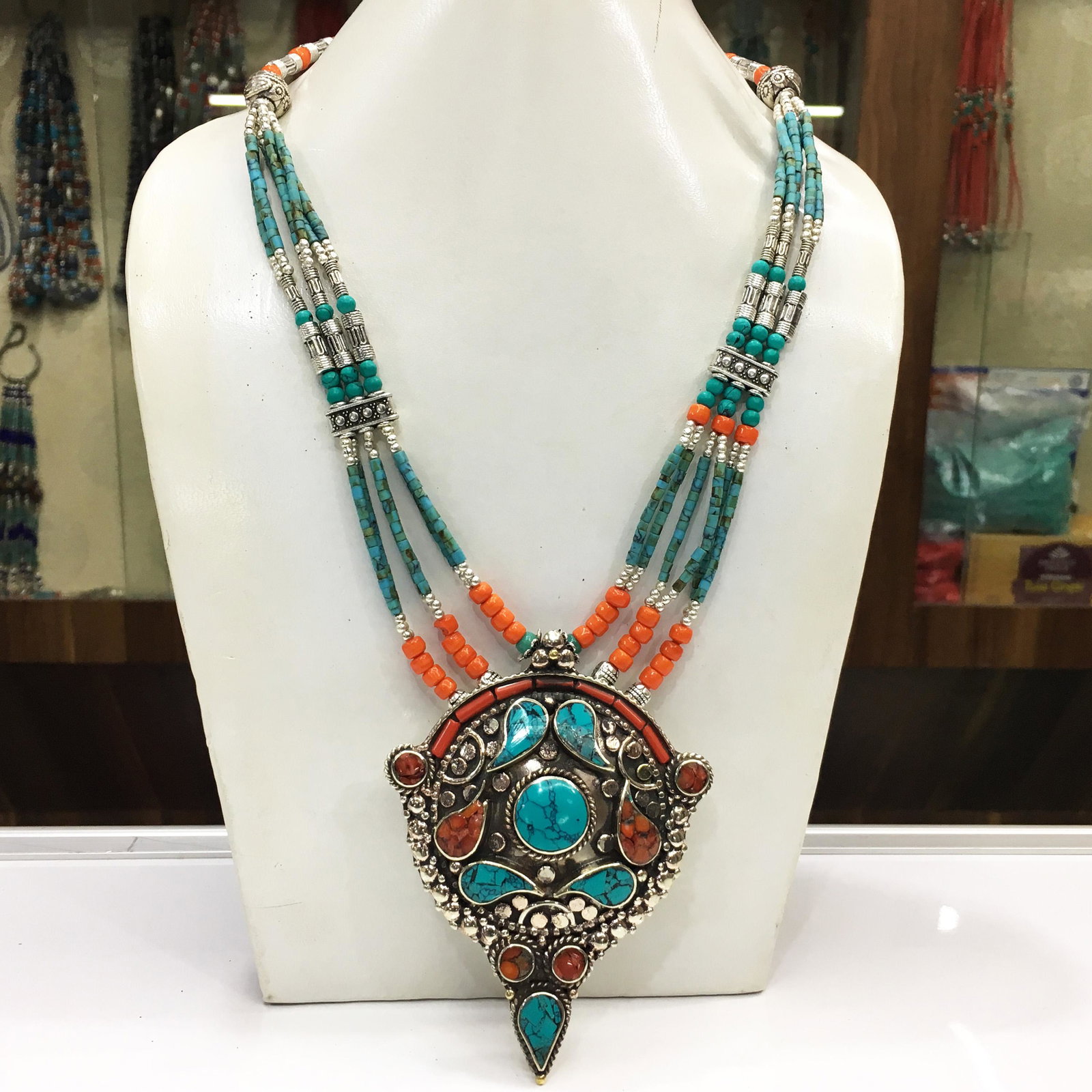 Tibetan Buddhist Turquoise & Coral Pendant Necklace: Tibet Natural Stone Hand Made Coral Necklace......This elegant Necklace was handcrafted in Tibet, the home of exquisite jewelry craftsmanship. It was skillfully made with large natural Turquoise, each
