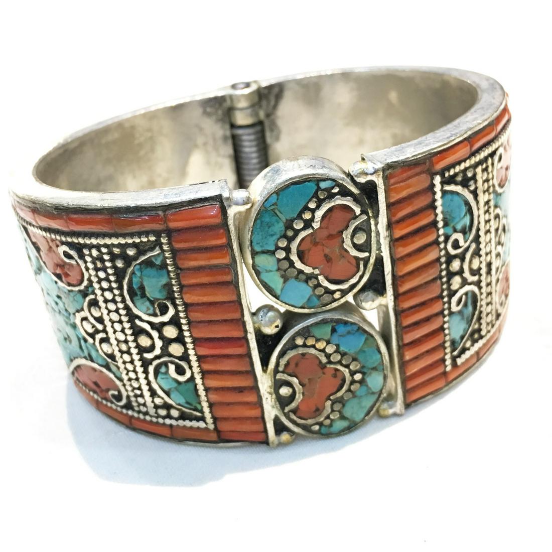 Tibetan Silver Turquoise & Coral Hand-Carved Ethnic: Tibetan Silver Turquoise Hand-Carved BangleWeight: 80 Gram ApproxGemstones: Turquoise & CoralBrand: HandmadeBangle Size: FreeCountry/Region of Manufacture: Nepal