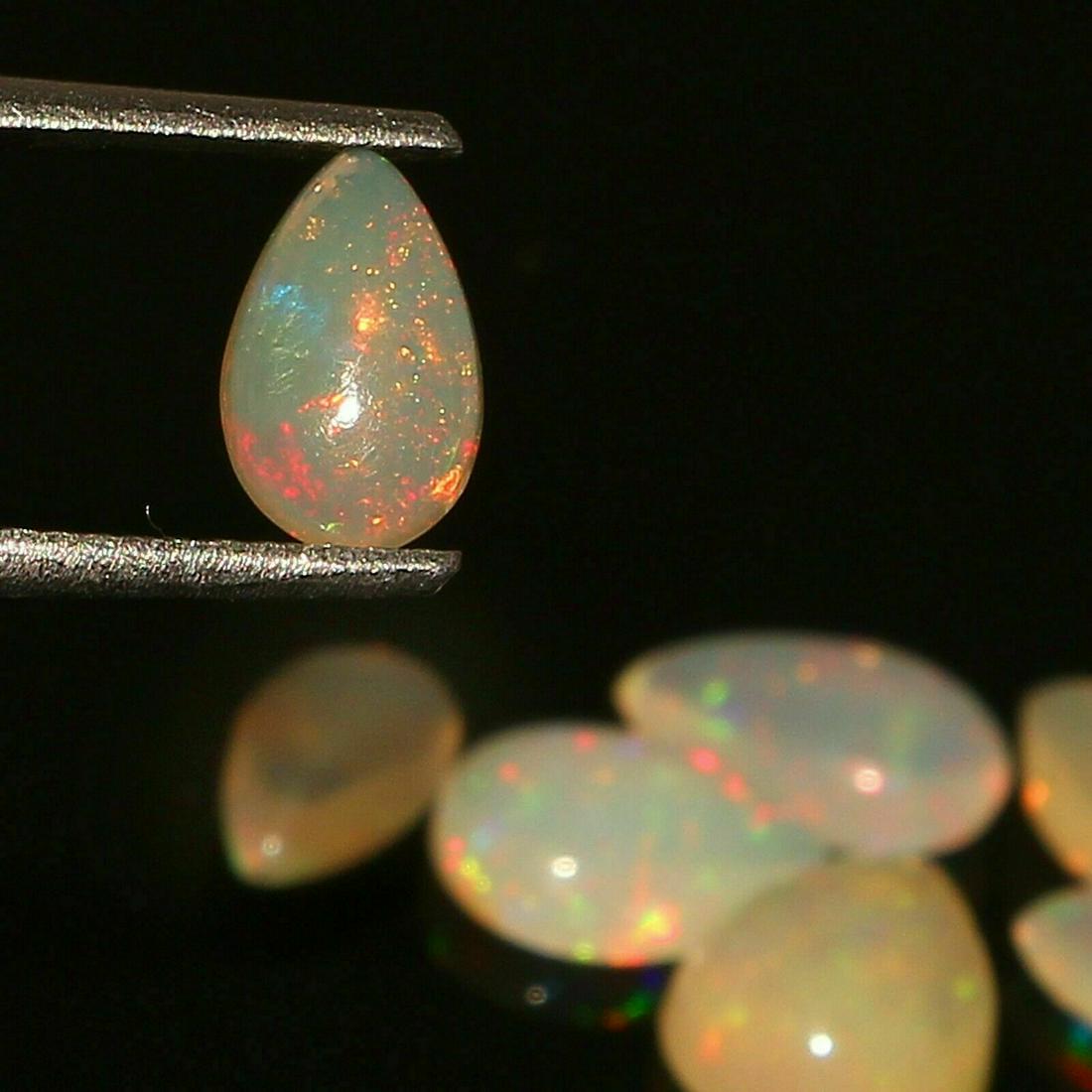 Natural Ethiopian Opal 3.60 Cts Welo Fire 7 Pcs: Shape:PearCut Grade:SMOOTHCountry of Origin:EthiopiaTreatment:None (No Enhancement)Country/Region of Manufacture:IndiaWidth:6,5,4 MMNatural/Lab-Created:NaturalTotal Carat Weight (TCW):3.60Natural/Lab 