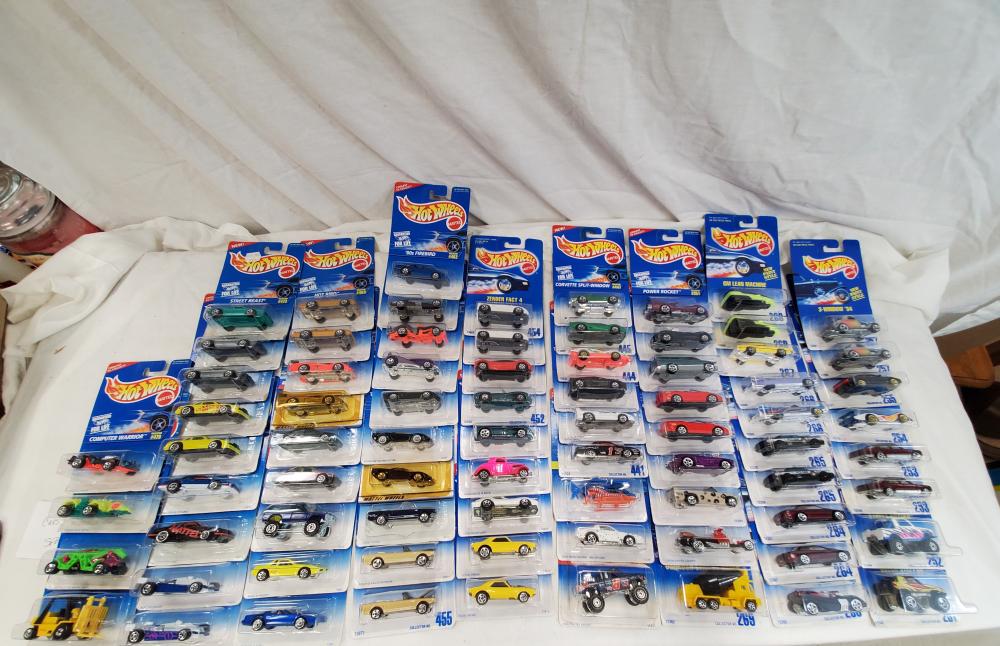 Lot of 77 Hot wheels cars new old stock on cards: all cars are mint on card and range from the 90's to the early 2000's