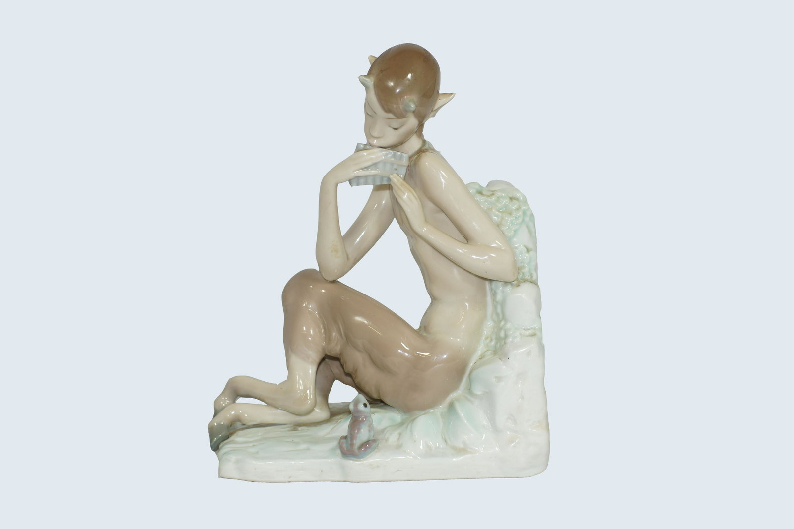 Lladro Porcelain Fantasy Satyr Figurine: Lladro Rare Vintage Fantasy Satyr with Sea Shell - half horse/half satyr sitting and playing sea shell. Made in Spain. Size 7" X 9". Book End.