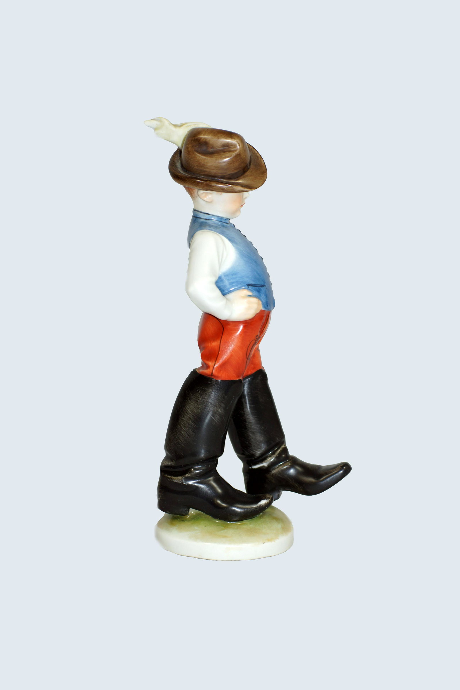 Vintage Herend Porcelain Boy Figurine: Vintage Herend Porcelain Figurine of adorable "Little Peasant Boy in Big Fathers Boots" or "Tom Thumb." Dated 1948. Beautiful deep colors with intricately detailed face and clothing accents. We love h