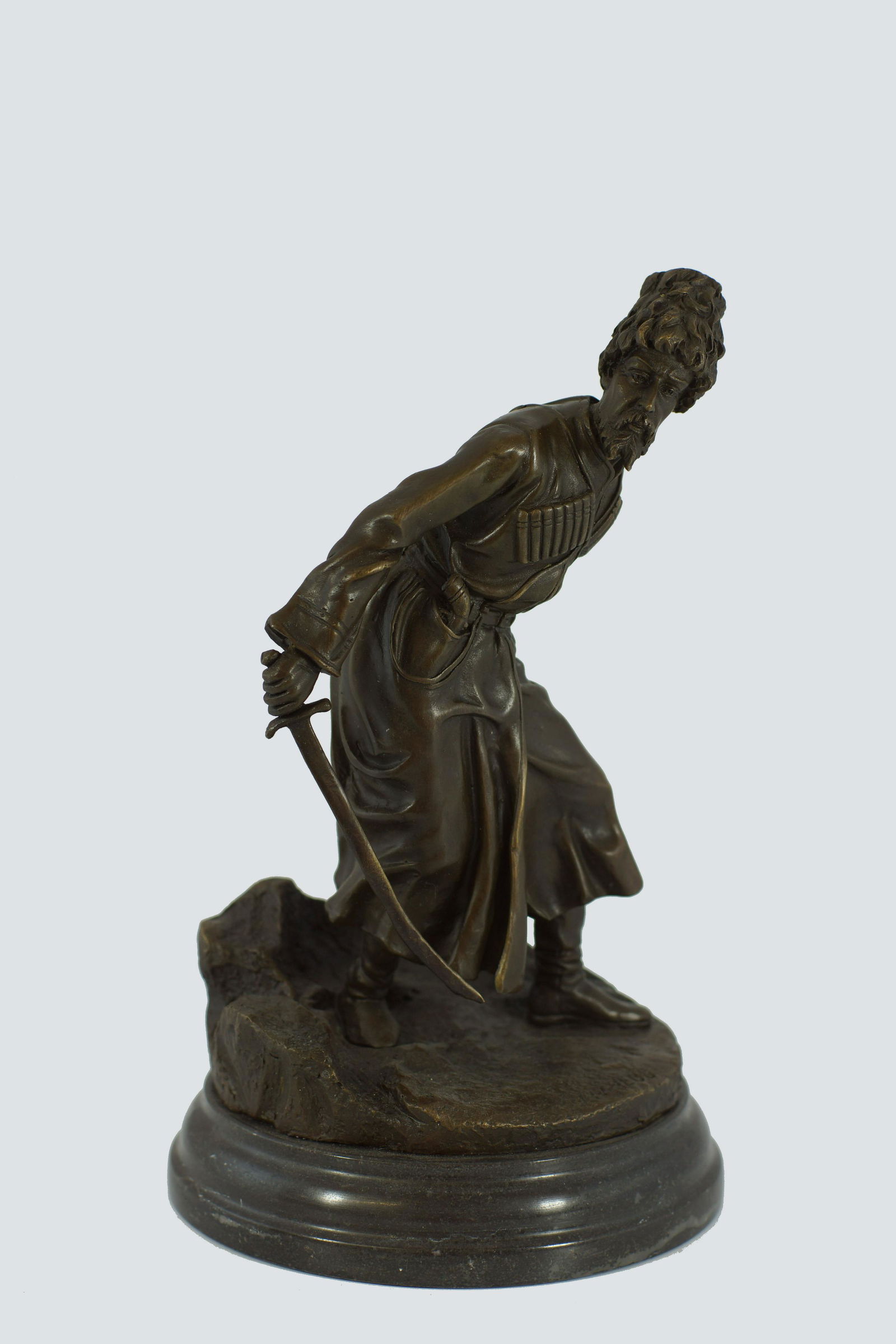 RUSSIAN BRONZE FIGURE OF COSSACK Vassili Grachev: Bronze figure of foot Cossack with drawn sword by Russian Artist Vassili Yacovlevitch Grachev (1831 - 1905). The statue is signed GRACHEV in Russian on the base. Size h 10".