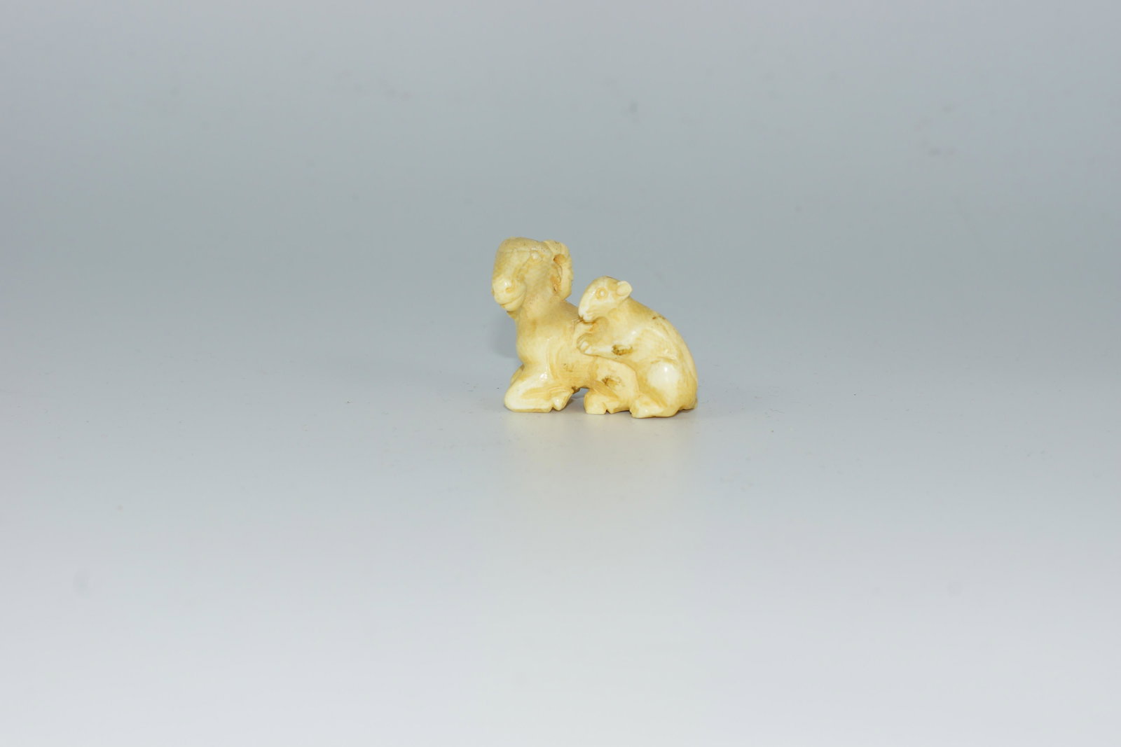 Antique Japanese Netsuke Ram with Rat: Antique or Vintage Japanese Carved Netsuke Figurine Ram with Rat. Size 1.75".