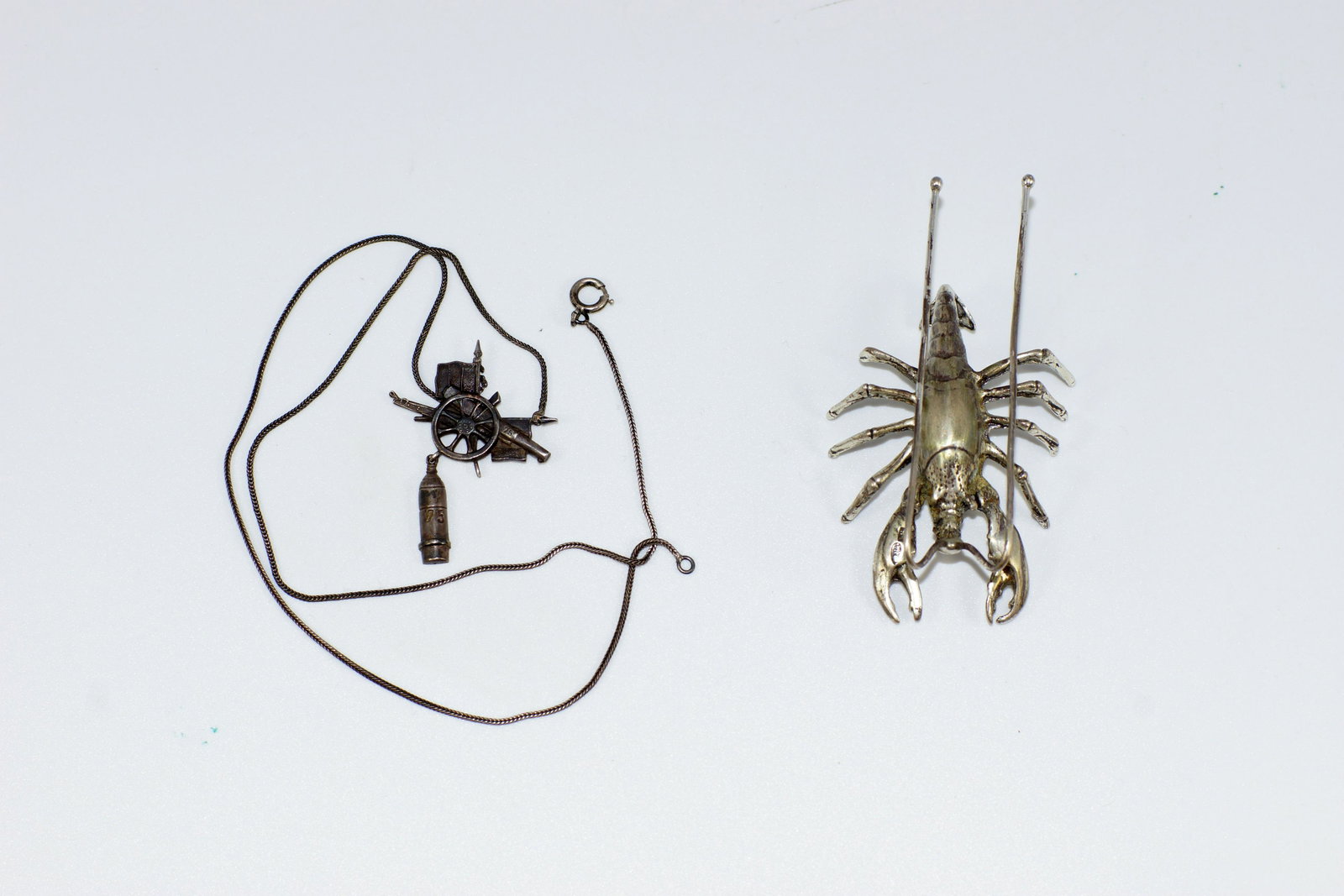 Antique Silver Decorative Items Set of Two: Antique Silver Decorative Items. Silver Necklace featuring militia symbols. Total Size 18.5". Sterling Silver Lobster Tableware Figurine. Size l 3".