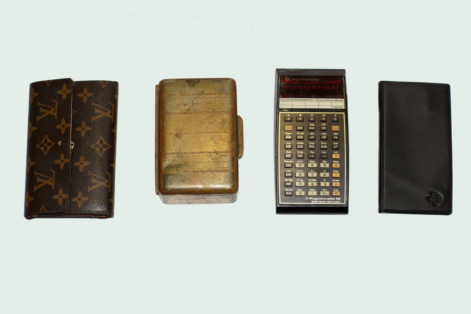 Vintage Assorted Items: First Item: Vintage Brown Louis Vuitton Women's Wallet made in France. Size: L 6" x W 3.5. Second Item: TI Programmable 59 Solid State Software Calculator. Size 6" x W 3". Third Item: Vintage Texas In