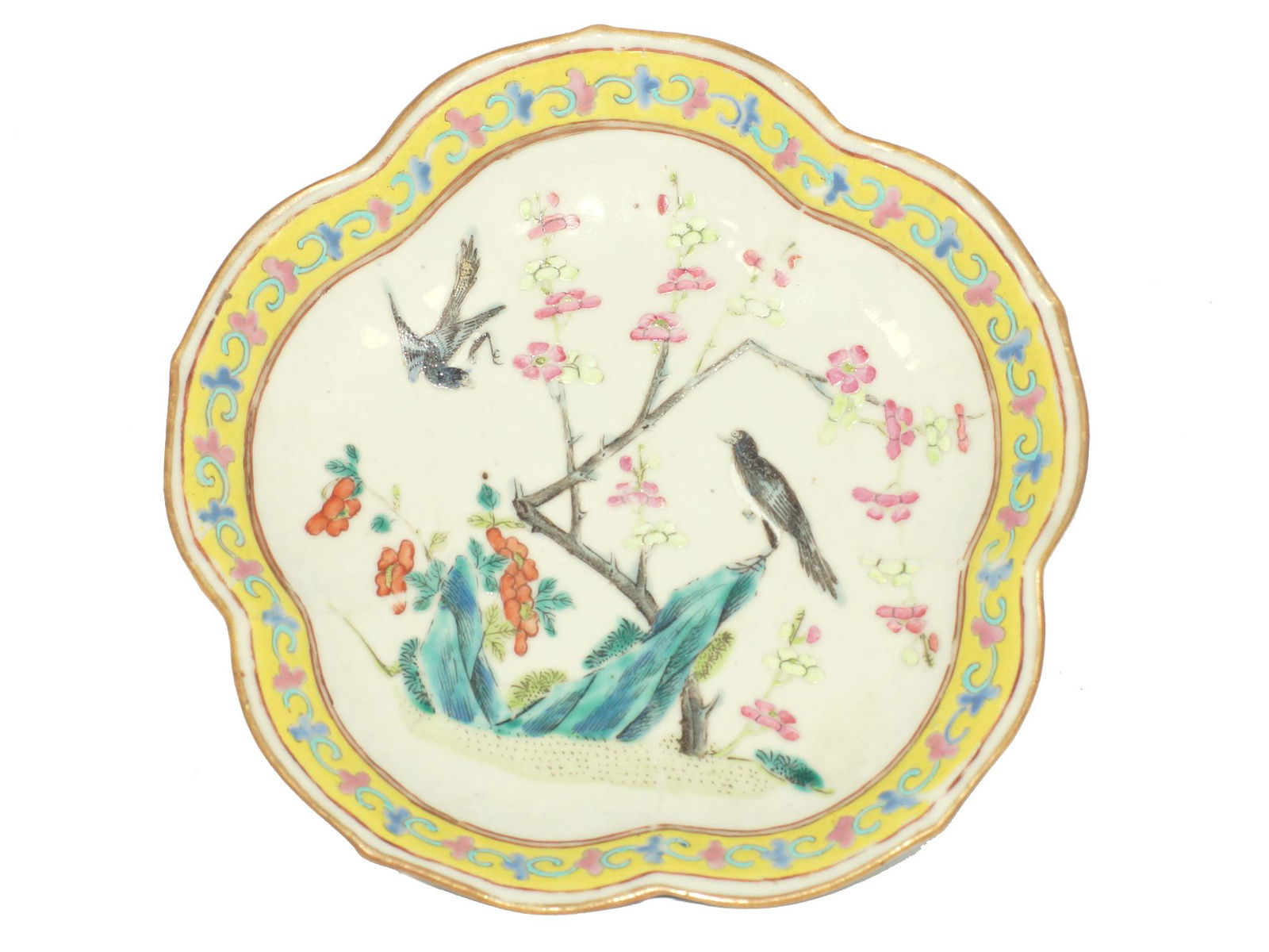 An Antique Chinese Famille Rose Porcelain Dish: Decorated with a nature scene with birds and flower tree in the middle. The geometrical pattern on the yellow ground at the stepped rim and wavy gilded edge.Â Floral designs on the underside - one i