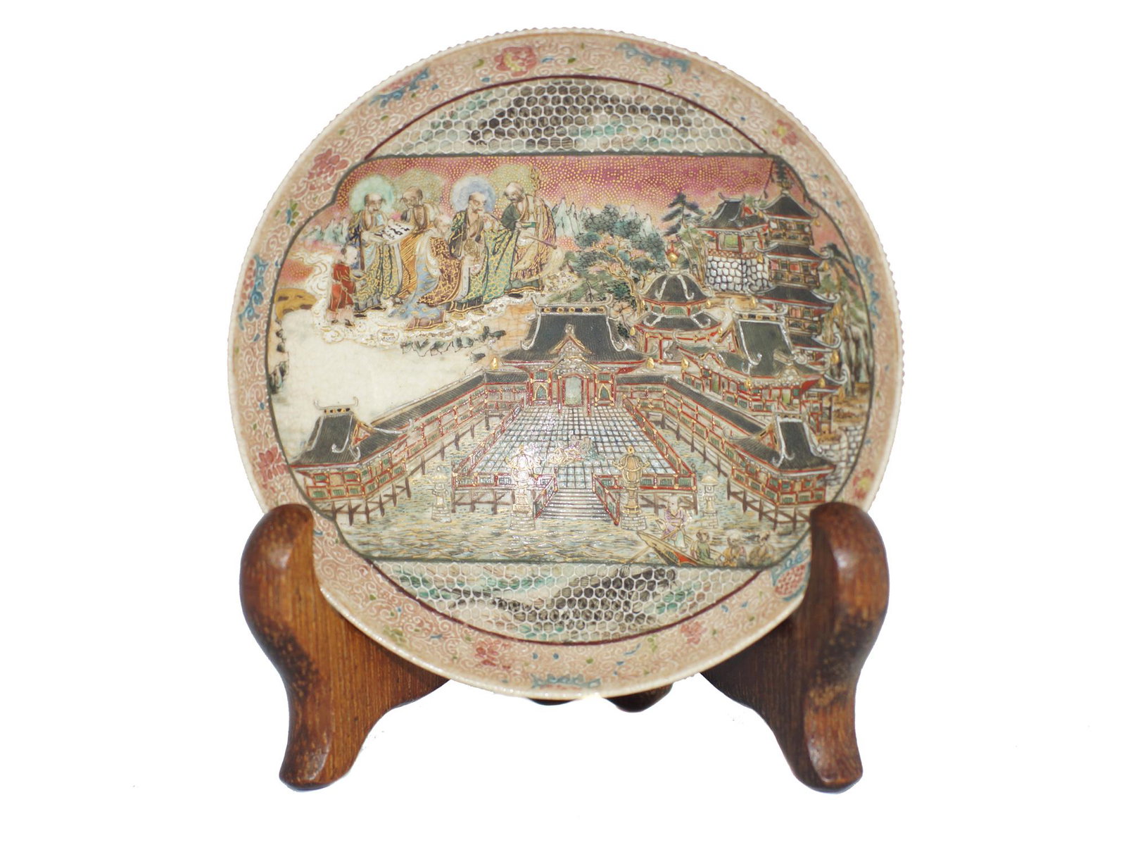 An Antique Japanese Satsuma Meiji Period Plate: Depicting a castle in the picturesque background and Gods looking down from the sky. Underside has floral designs, crackled background and dotted patterns, brown underglaze mark. Ca. Late 19th Century