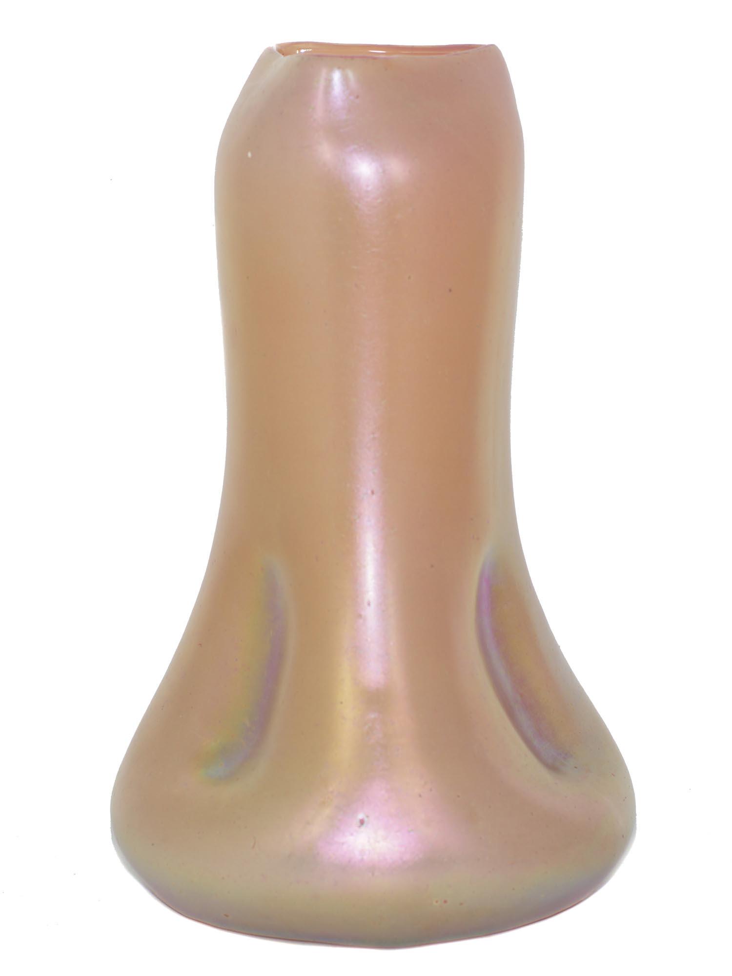 An Antique Loetz Glass Vase Phaenomen Genre: In pearl pink, the vase has an irregular shape with a pinched appearance at the bottom. Ca. Early 20th Century. Size: h: 11 1/2 in.